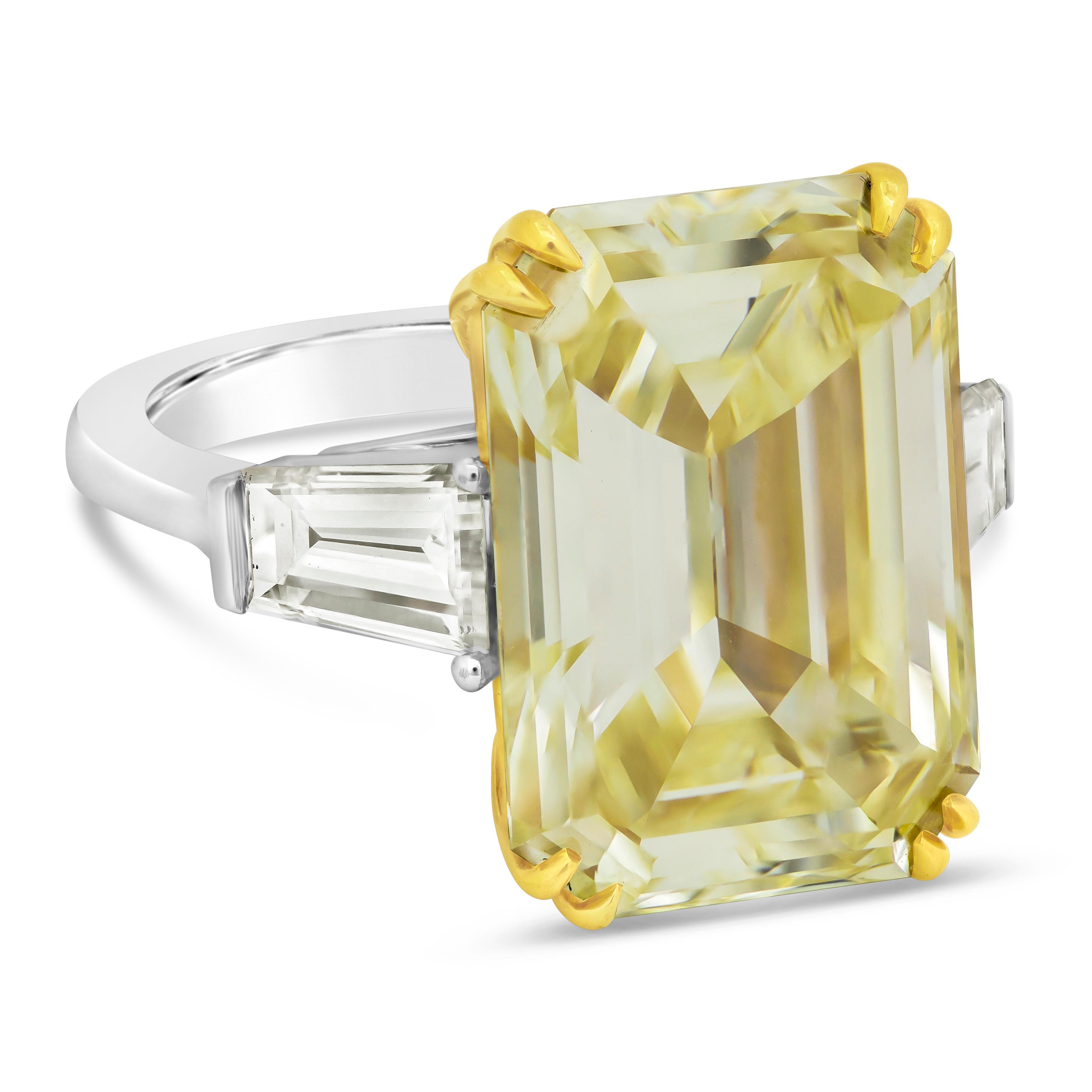 A gorgeous high-end engagement ring, showcasing a 14.54 carats emerald cut diamond certified by GIA as Fancy Yellow color and VVS2 clarity, set on an eight prong 18K yellow gold basket. Accented by tapered baguette cut diamonds weighing 1.70 carats