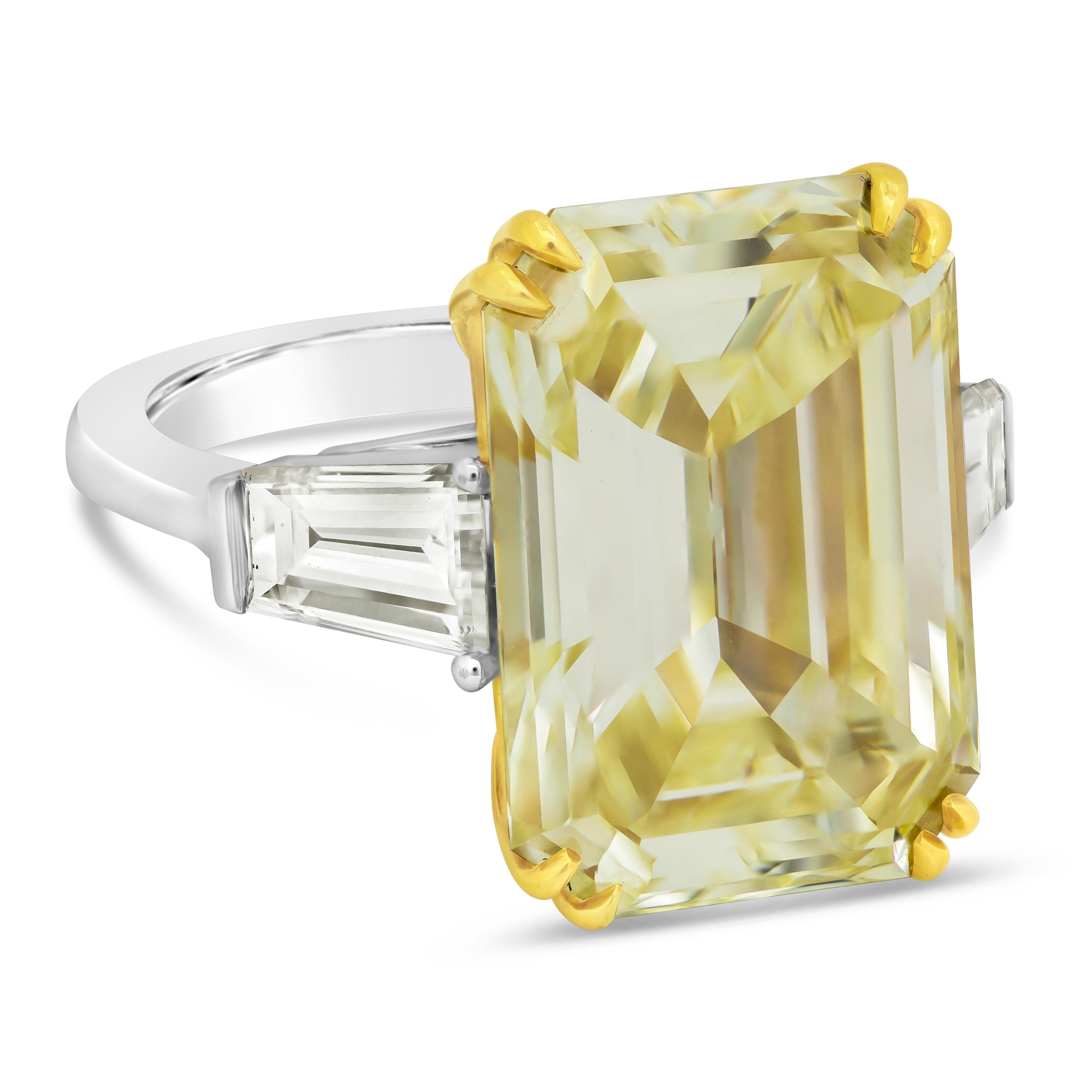 A very color-rich diamond. Showcasing a three-stone engagement ring features a GIA Certified 14.54 carat emerald cut diamond, Fancy Yellow and VVS2 in Clarity. Flanking the center are 1.70 carats total of tapered baguette diamonds. Made with