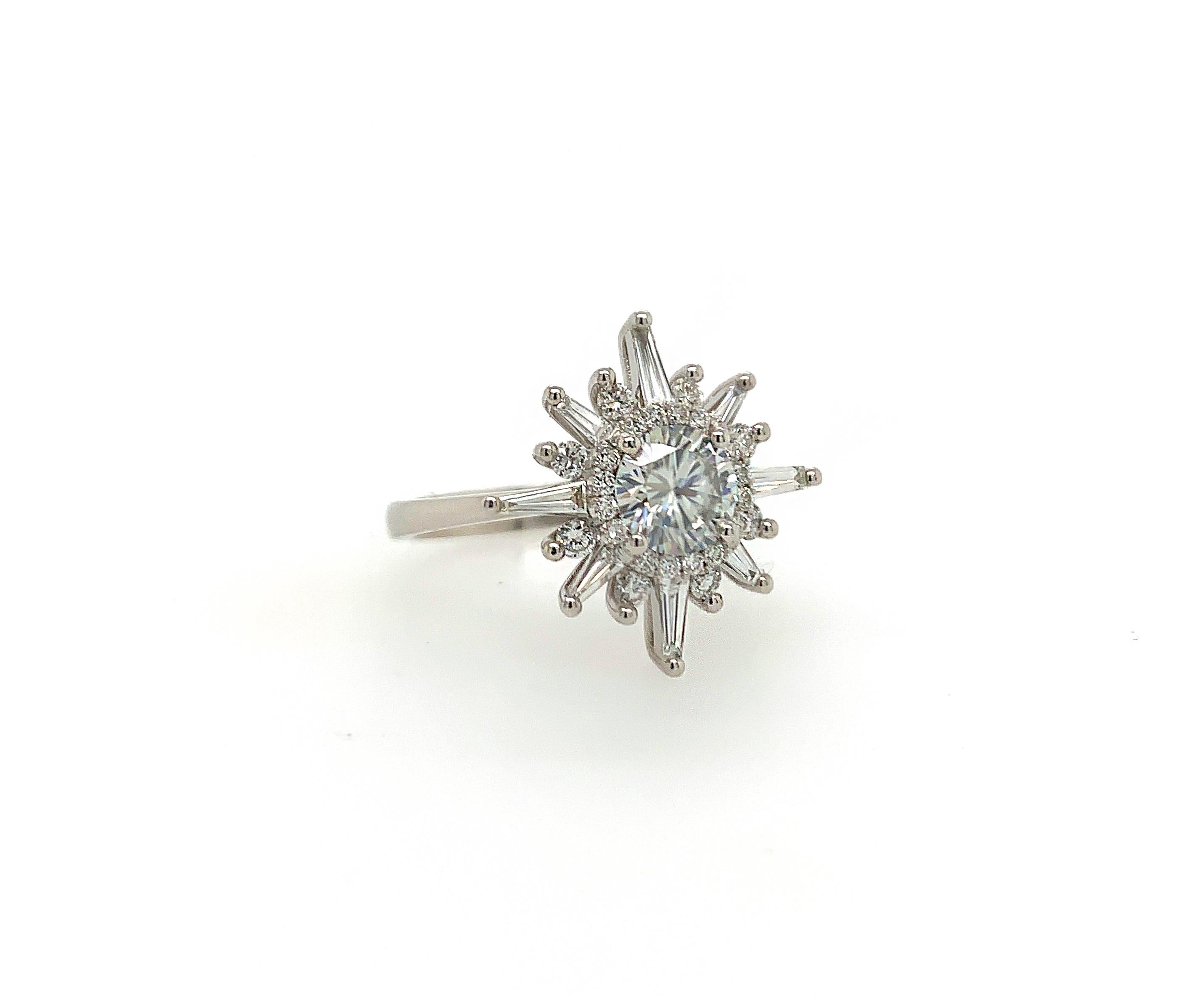 This beautiful ring flaunts a 1.00 carat natural round brilliant white diamond surrounded by a halo, 8 round brilliants and 8 tapered baguettes. The design is inspired by the magical aura of the Northern Star which is the brightest star of its