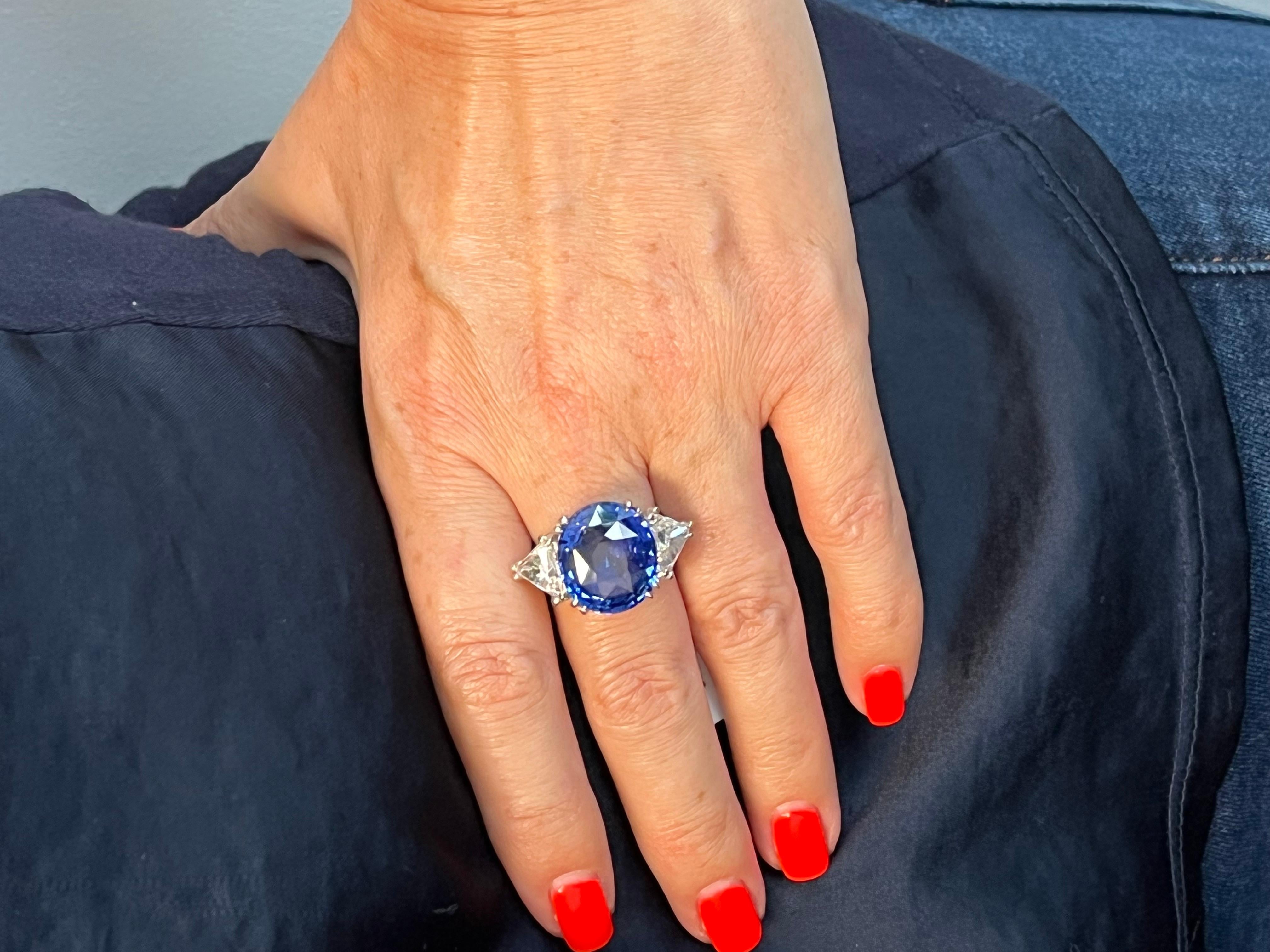 Item Description:
This exquisite 14.64-carat G.I.A. certified natural blue sapphire takes center stage in this mesmerizing 18 karat white gold ring. This oval-shaped sapphire exhibits the deep, rich blue hue that sapphires are cherished for.