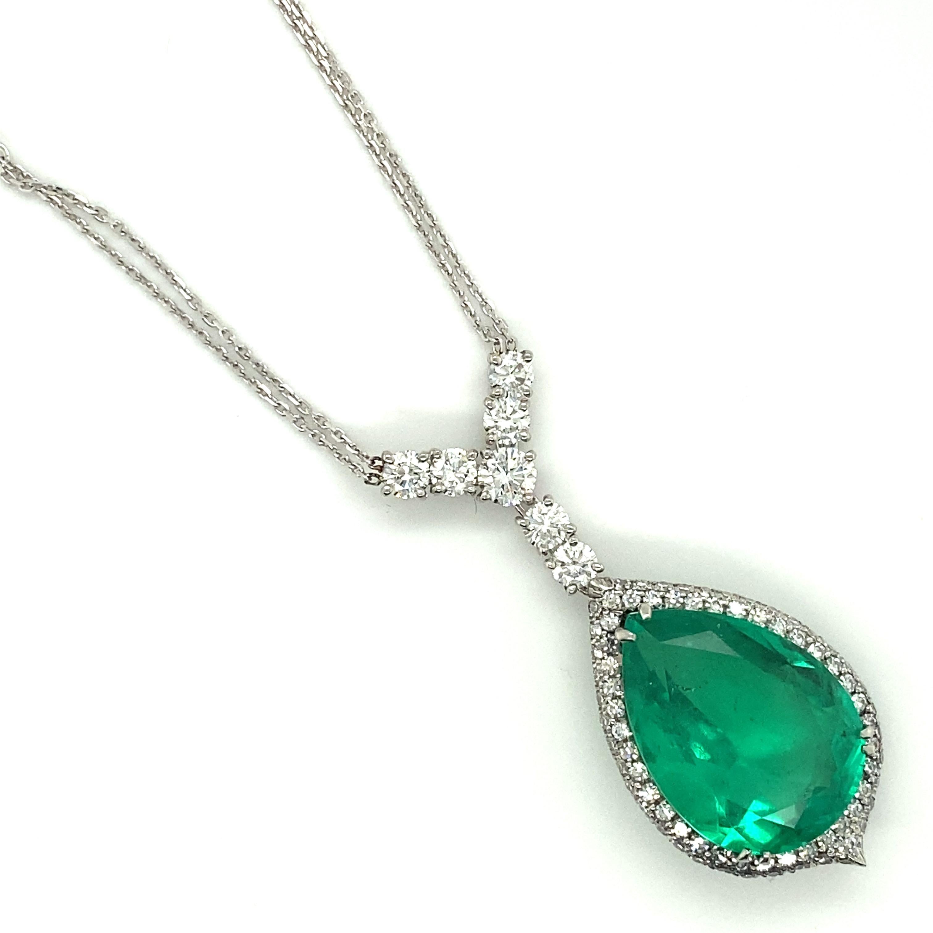 This hand-crafted platinum pendant was custom designed to accentuate the central 14.79ct GIA certified Colombian emerald.  This large stone exhibits a crystal, bluish green color and excellent clarity, especially by Colombian emerald standards.  