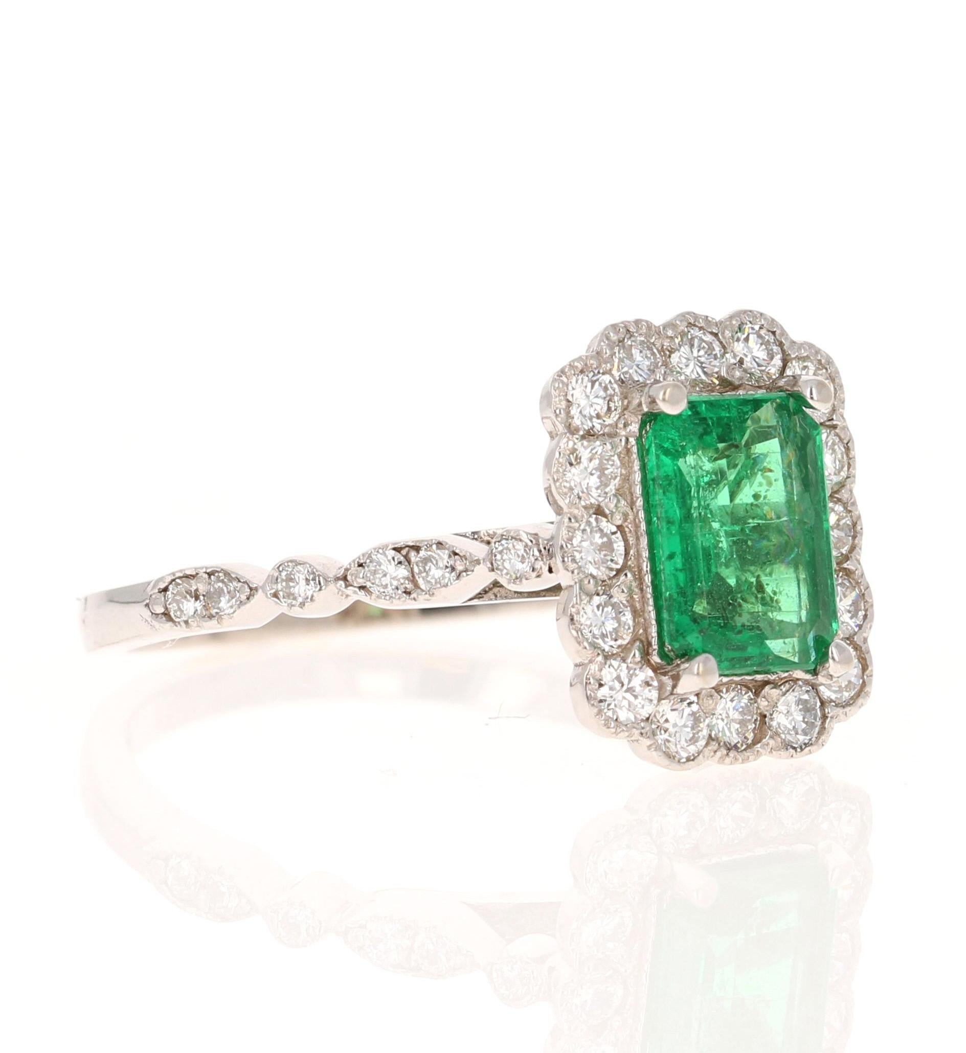 A beautiful & classic setting holding a Natural Emerald Cut Emerald that weighs 0.95 carats and is surrounded by 28 Round Cut Diamonds that weigh 0.54 carats with a clarity & color of SI1-F.  The total carat weight of the ring is 1.49 carats.

The