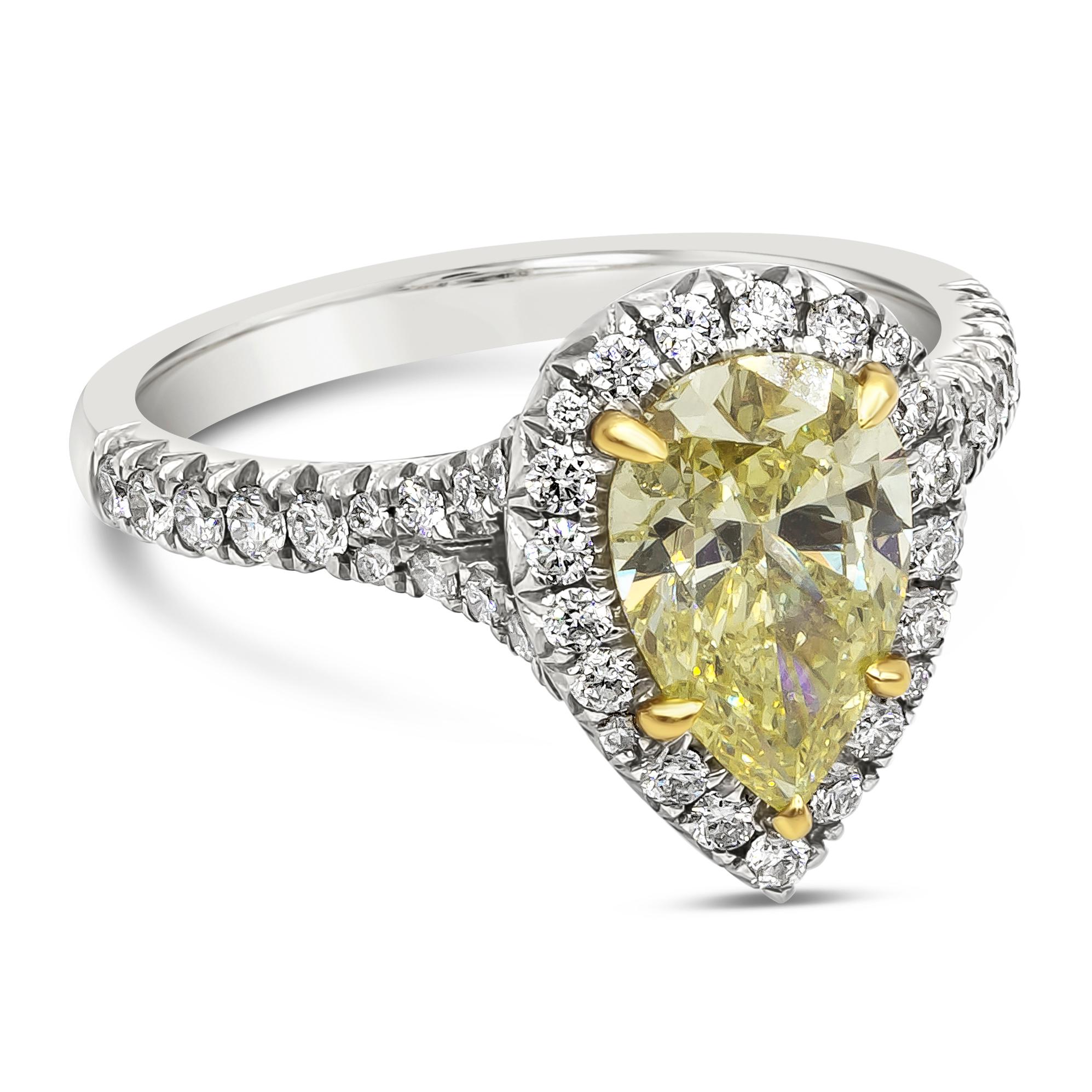 A color-rich engagement ring showcasing a 1.49 carat pear shape yellow diamond certified by GIA as Fancy Intense Yellow Color, SI2 in clarity set in five prong setting made in 18K yellow gold. Center diamond is surrounded by a row of round brilliant