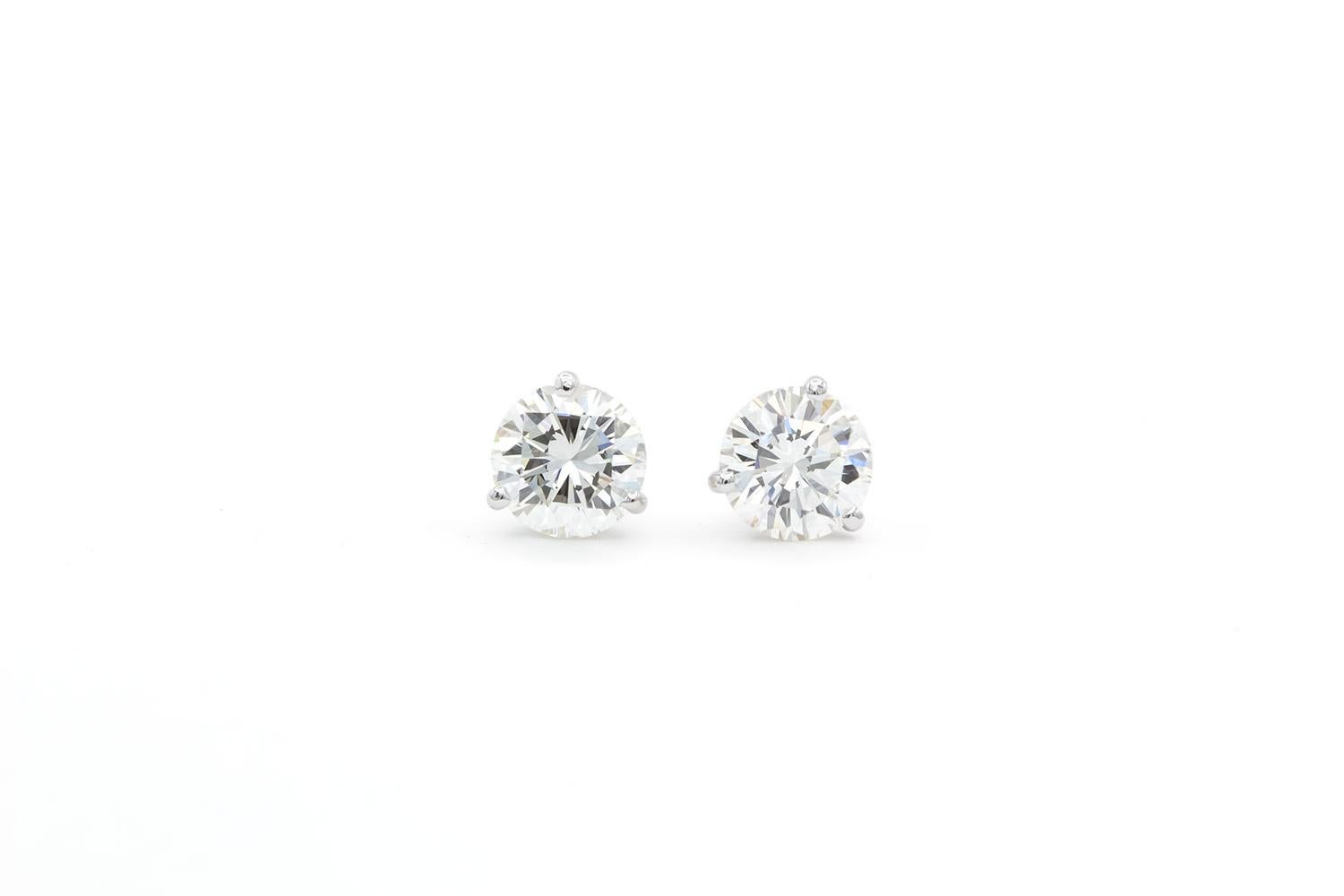 We are pleased to present these GIA Certified 14k White Gold & Natural Round Brilliant Cut Diamond Martini Stud Earrings. These beautiful earrings feature two GIA certified natural diamonds. One 1.51ct J/VS1 Round Brilliant Cut Diamond and one