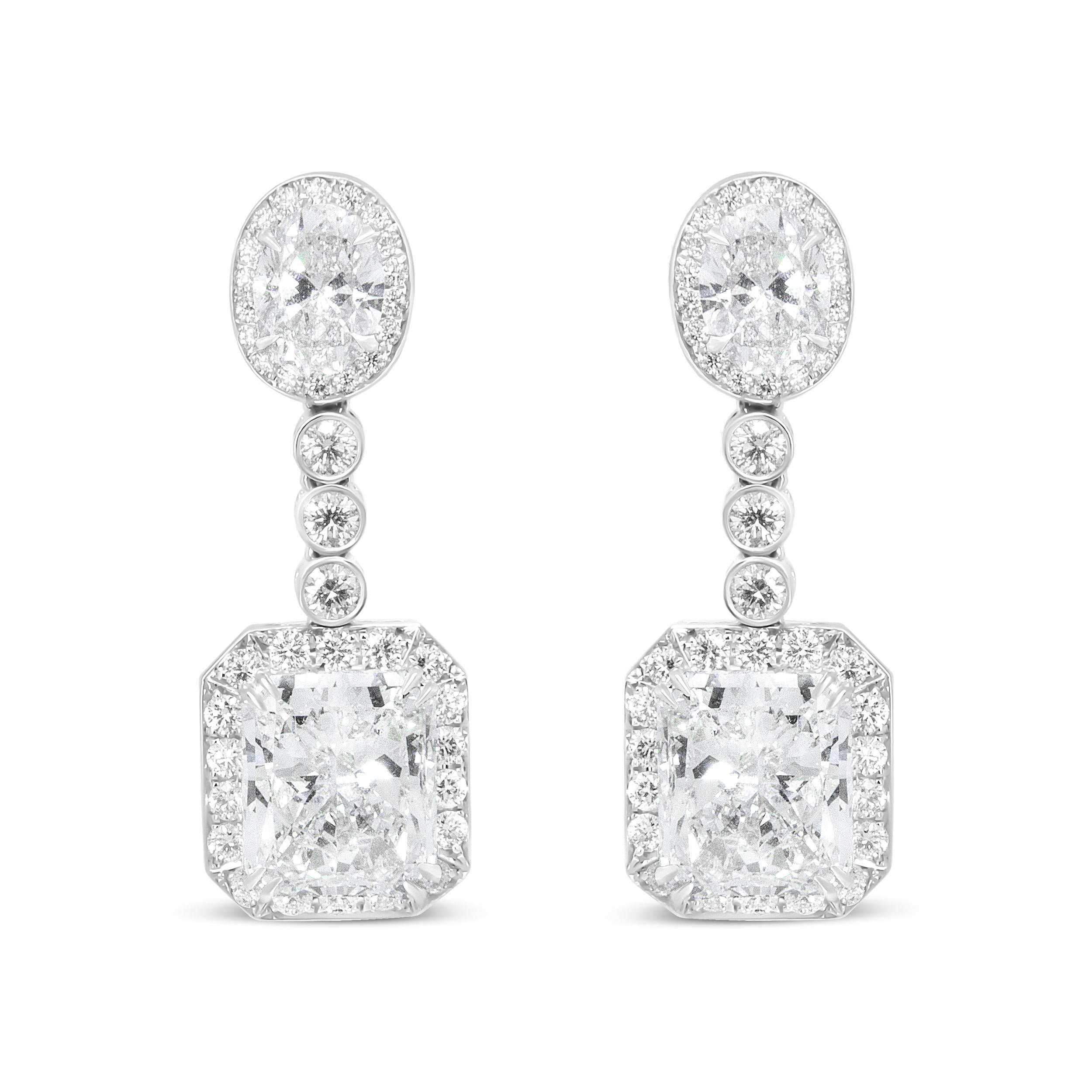 Celebrate the special moments in life with this pair of exquisite GIA Certified emerald and oval cut diamond dangle drop earrings. Graceful shapes, artful femininity, and an exquisite display of precious stones are at the center of this masterpiece