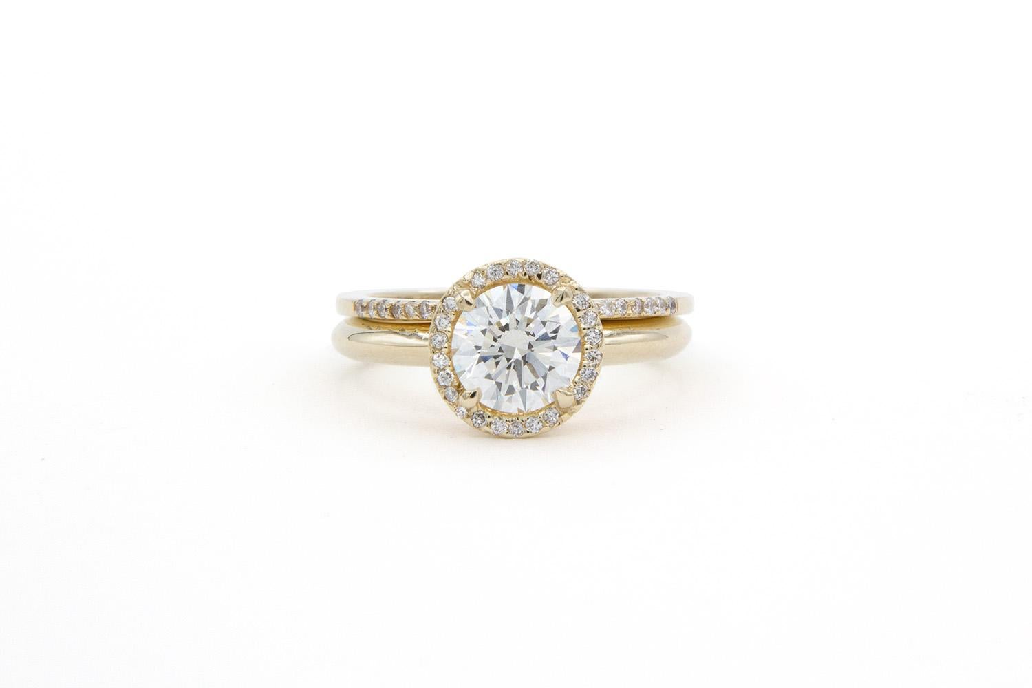 We are pleased to offer this GIA Certified 14K Yellow Gold & Diamond Halo Engagement Ring Set. This beautiful ring set features a GIA certified & laser inscribed 1.04ct K/IF (internally flawless) Round Brilliant cut center diamond set in a stunning