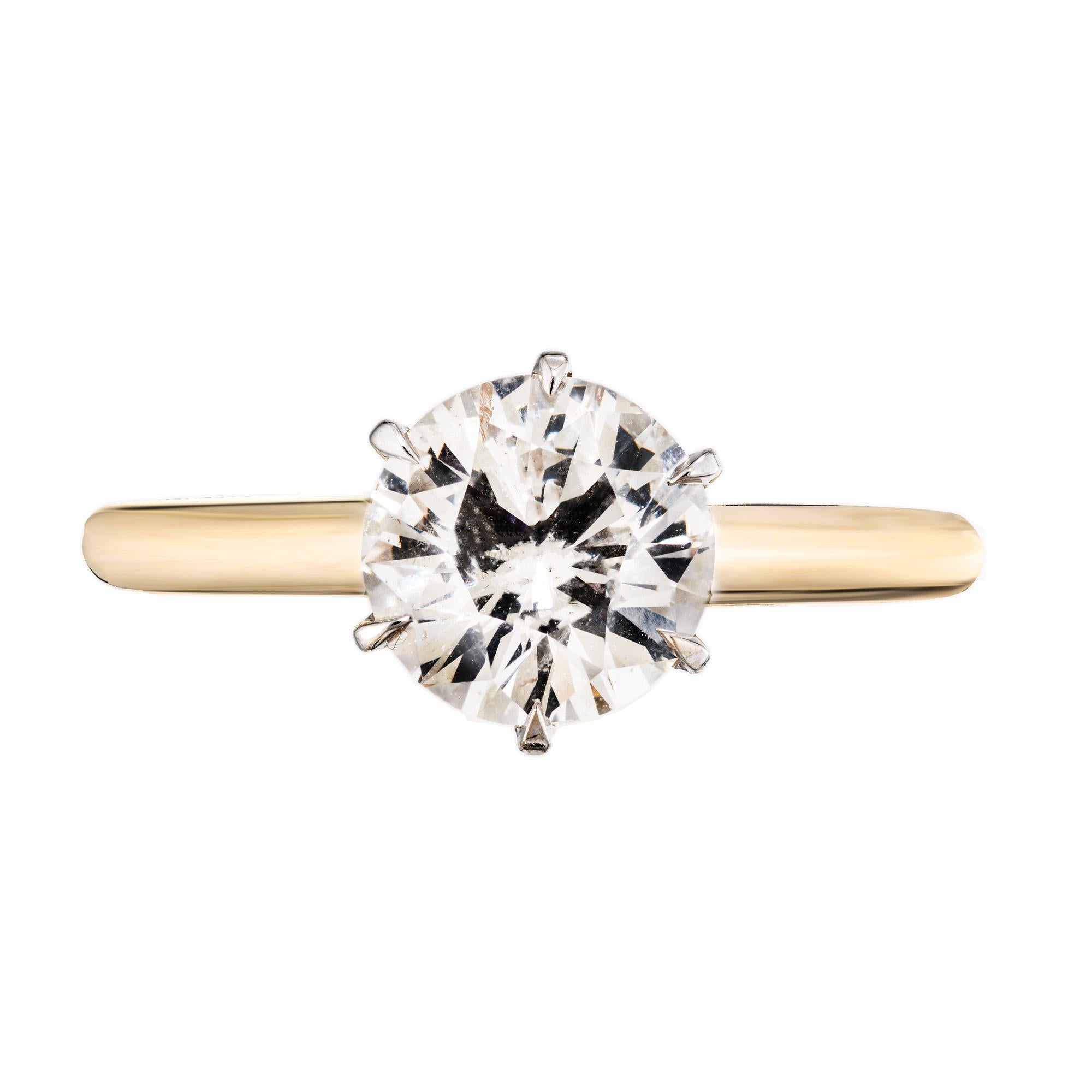 Classic six prong diamond engagement ring. GIA certified 1.5ct round brilliant cut diamond mounted in a two tone 14k yellow and white gold solitaire setting. The stone has been meticulously graded and certified by the GIA as L, faint yellow and I1,