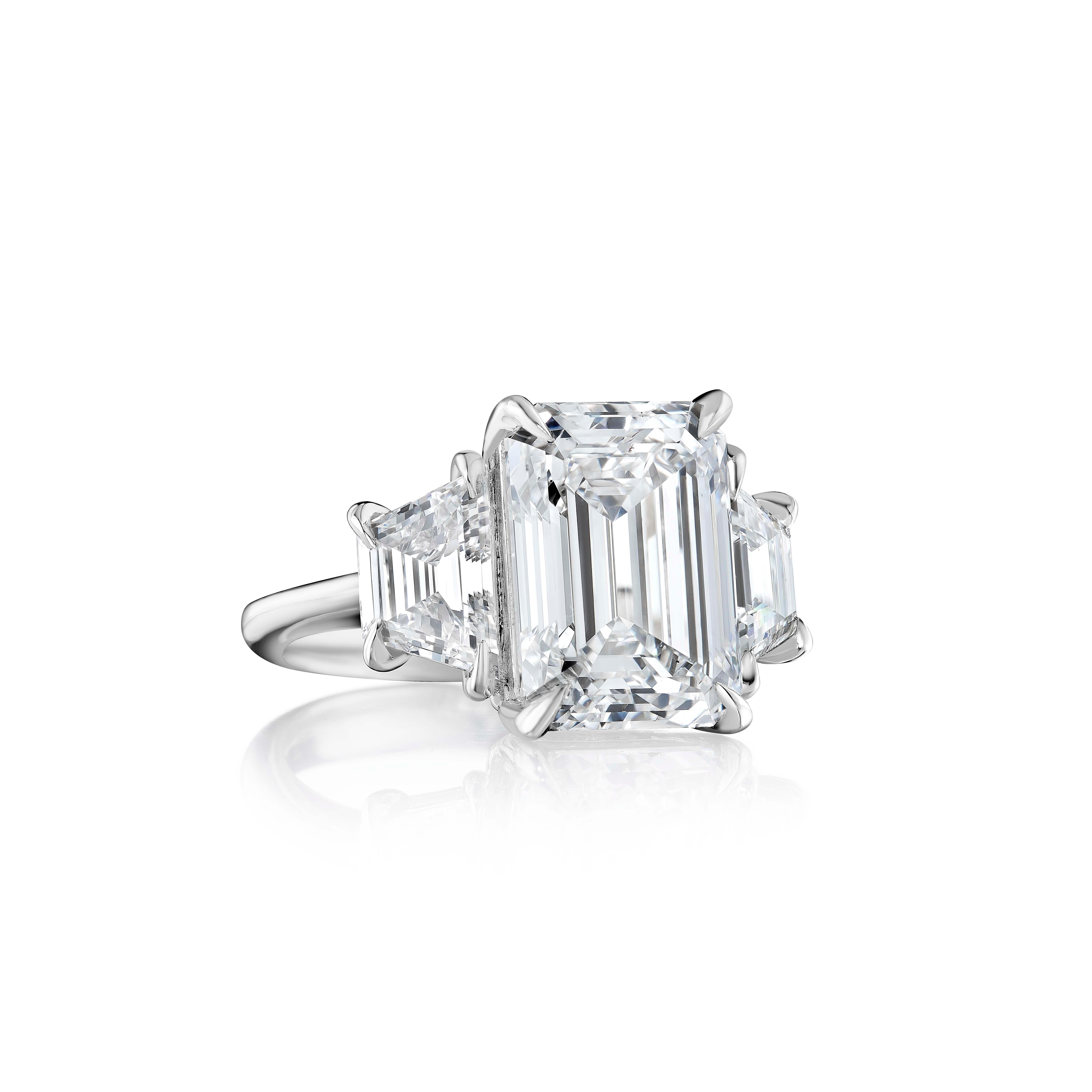 Emerald Cut Diamonds weighing 15.2 Carats, flanked by Trapezoid shaped Diamonds and set in Platinum.
Beautiful proportions and great life to this Diamond
Diamond is certified by GIA as H color and VS2 clarity.
Set in Platinum.
Size 6.

Style