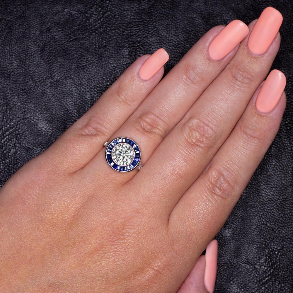 diamond and sapphire ring has a classic Art Deco style target design and features a gorgeous 1.5 carat excellent cut diamond! It is an excellent choice for an engagement or cocktail ring.

Highlights:

- Substantial 1.5 carat size diamond center

-