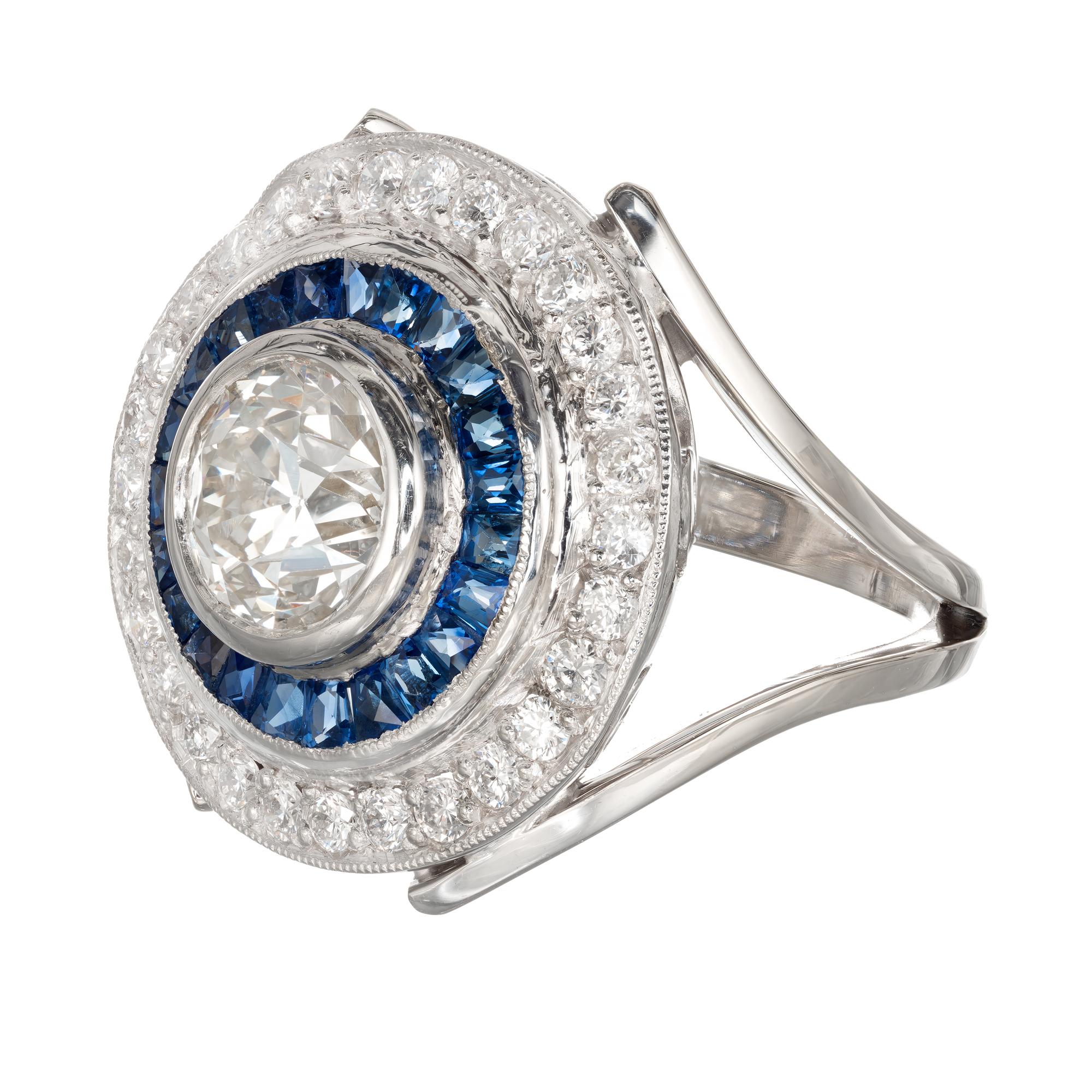 Diamond and sapphire halo cocktail ring. European brilliant cut center stone in a platinum and 18k white gold setting with a halo of calibre French cut sapphires and a halo of round full cut diamonds EGL certified. Created in the Peter Suchy