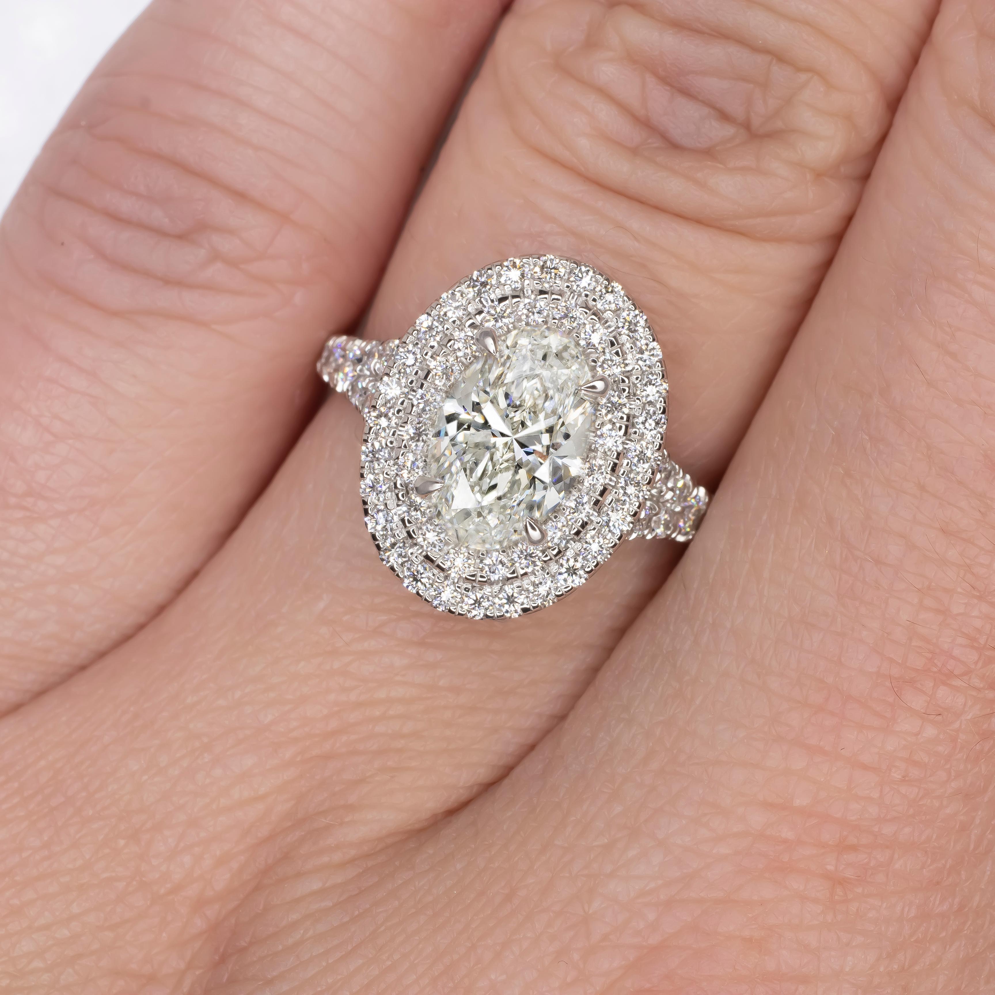 Exquisite in design and radiant in brilliance, this white gold engagement ring showcases a breathtaking 1.50-carat oval brilliant diamond, graded F for color and VS1 for clarity by the prestigious Gemological Institute of America (GIA). 

The