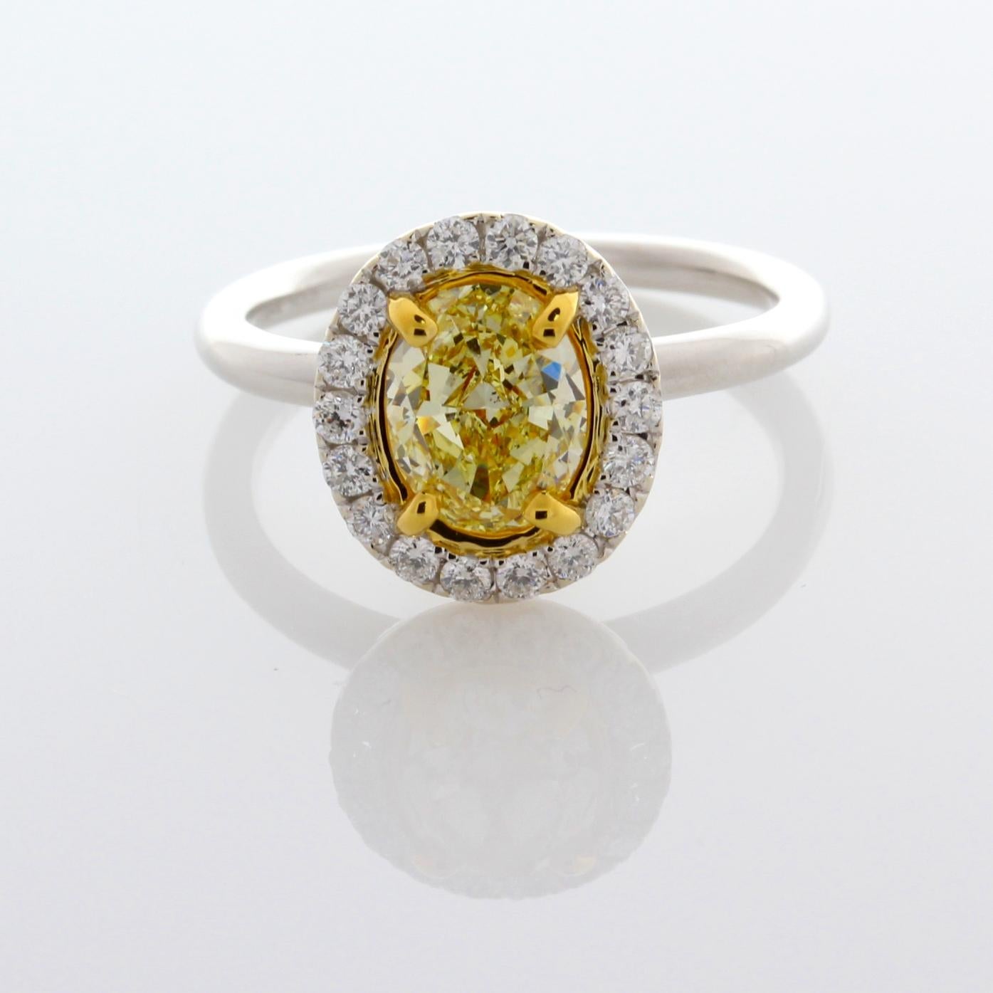 Incredible Deal on GIA Certified 1.50 Carat Oval Cut, Natural Fancy Light Yellow Even, SI1 Clarity, Diamond Ring, measuring 8.03-6.32x3.79. GIA Certificate #2181165984
Total Carat Weight on the ring is 1.90. 
This simple and elegant mounting is just