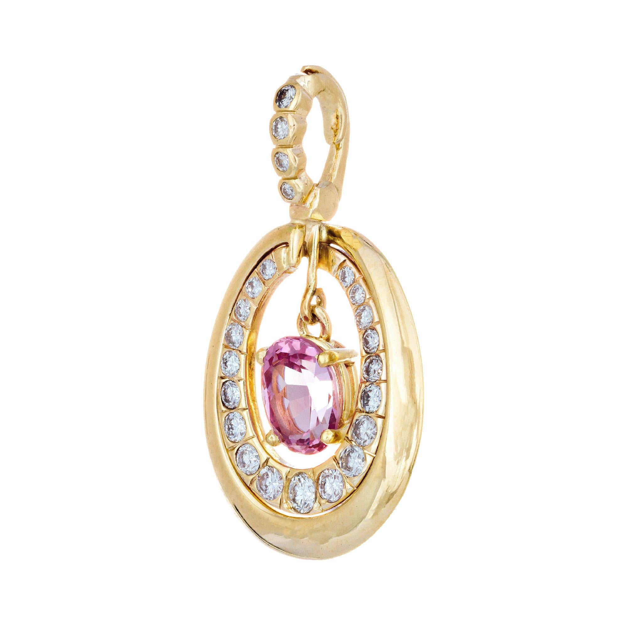 Oval pink spinel dangle center stone. 14k yellow gold pendant with a halo of graduated diamonds. Hinged enhancer bail with four graduated diamonds. 

1 oval natural untreated pink Spinel, approx. total weight 1.50cts, VS2, 8.25 x 6.10 x 4.45mm, GIA