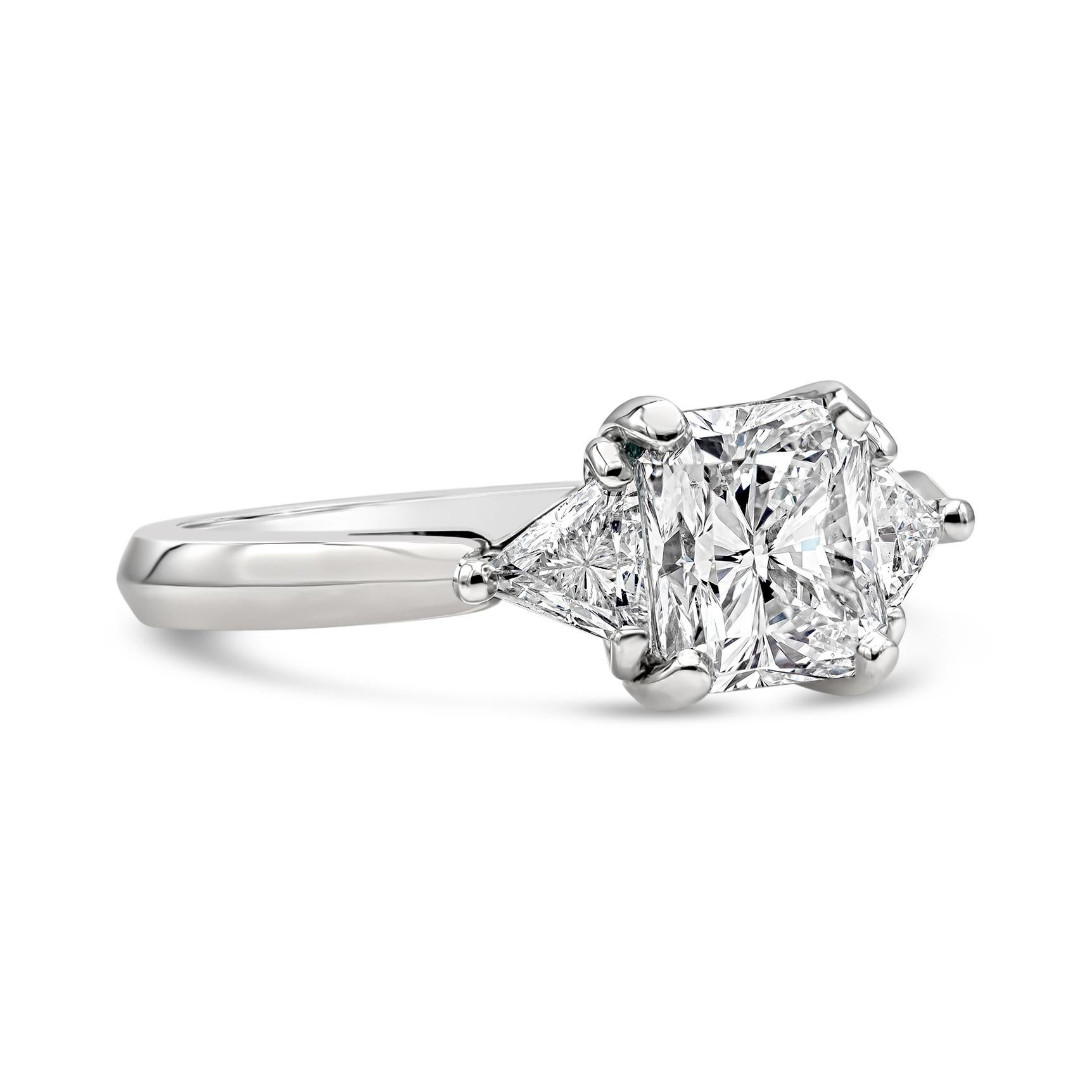 A classic three-stone engagement ring style showcasing a 1.50 carats radiant cut diamond certified by GIA as F color and SI1 in clarity, flanked by two trillion cut diamonds on either side weighing 0.47 carats total. Made in polished platinum. Size
