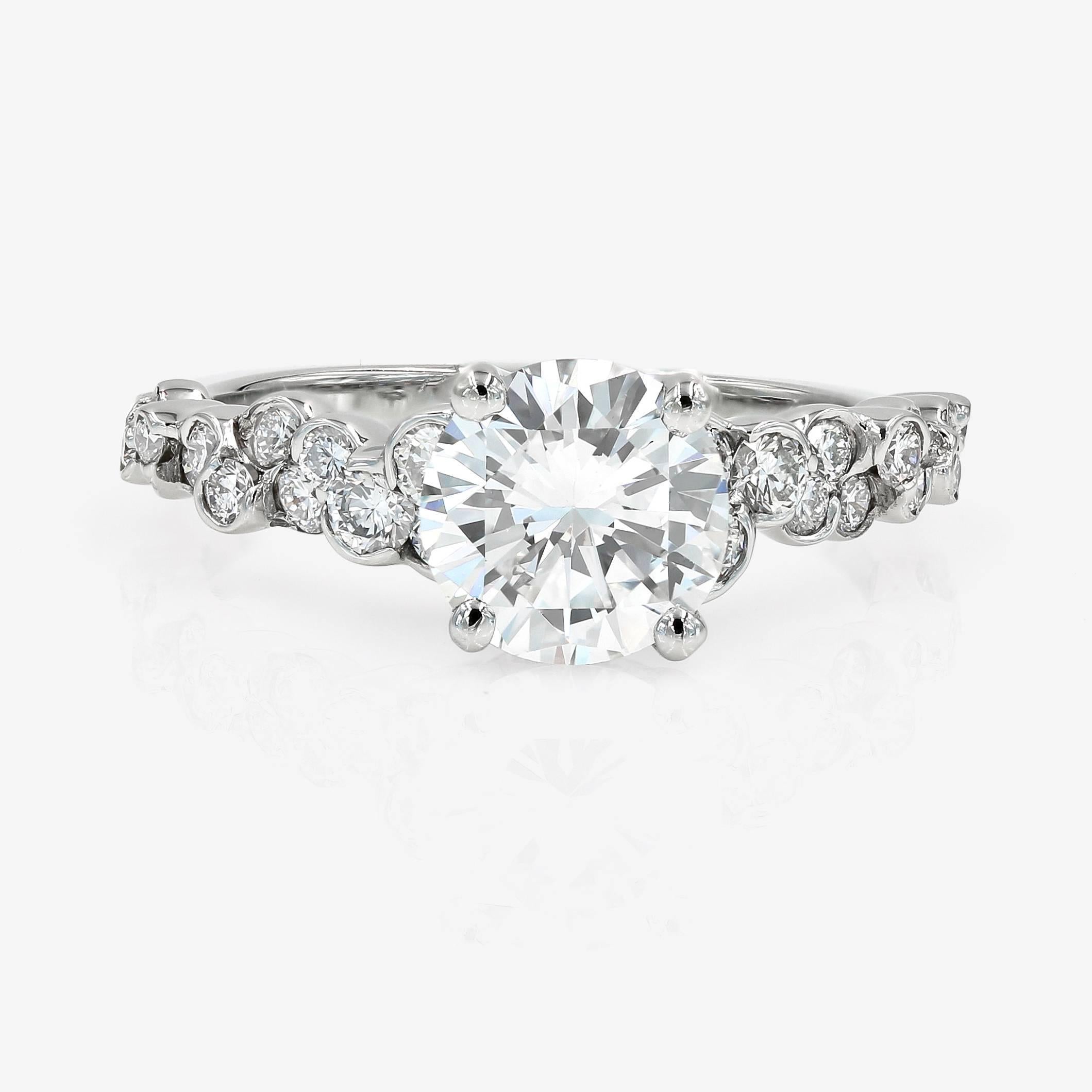 This Lester Lampert original CumuLLus Collection® style engagement ring in platinum features a 1.50cts. round center. It is surrounded by 36 ideal cut round diamonds= .73ct. t.w. (the rounds are G in color and VS in clarity)

This pieces comes with