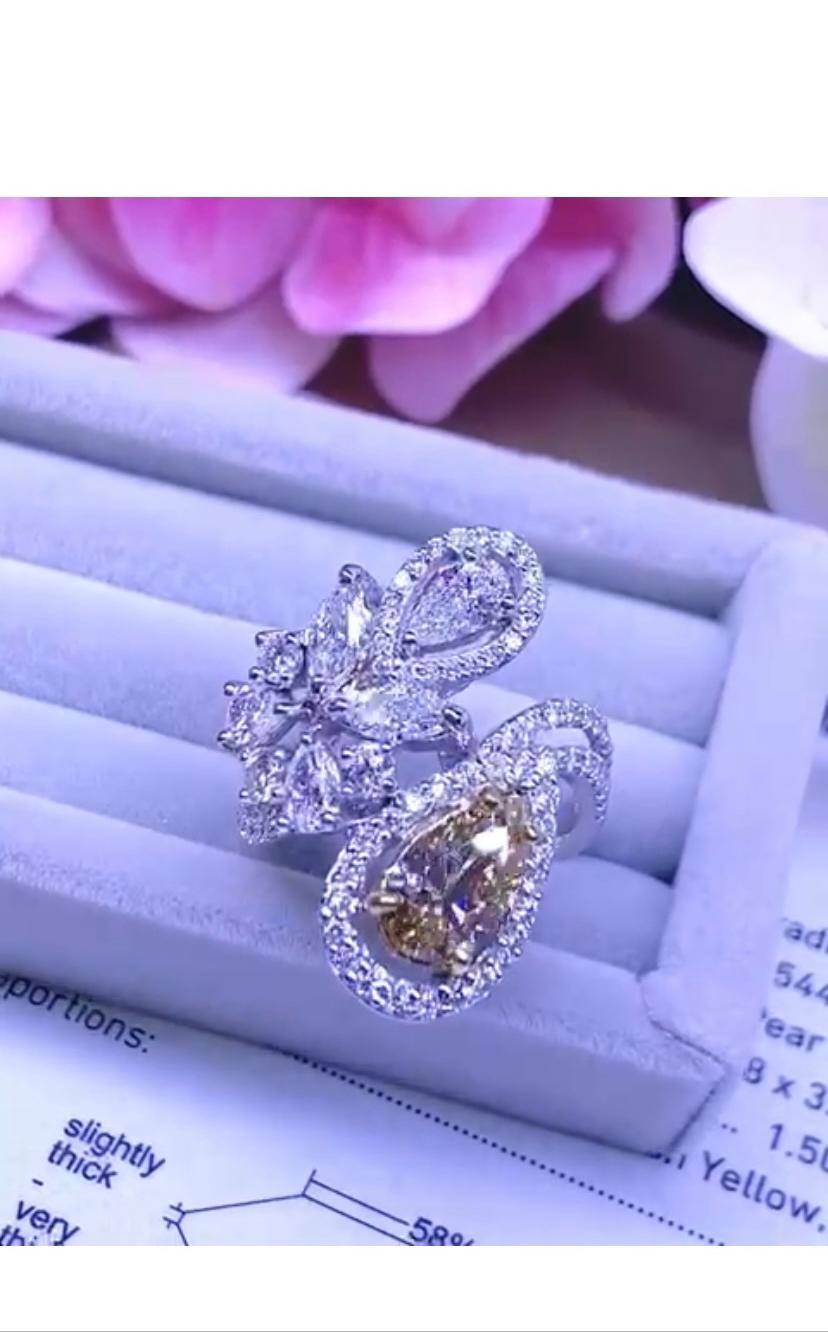 An exquisite piece of art , stunning design , so refined and chic style, a very glamour piece.
Ring come in 18k gold with a pear cut fancy yellow brownish diamond of 1,50 carats, VS2 clarity, and a pear cut diamond of 0,40 carats and 87 pieces of