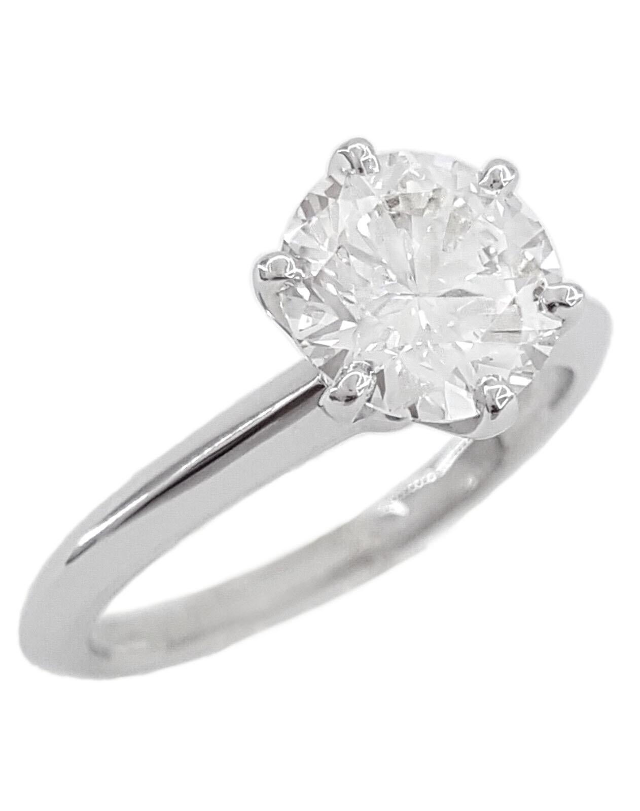 This exquisite ring showcases a GIA-certified 1.5-carat round diamond nestled gracefully in a stunning white gold setting. Graded by the esteemed Gemological Institute of America (GIA), the diamond boasts an exceptional f color grade, signifying a