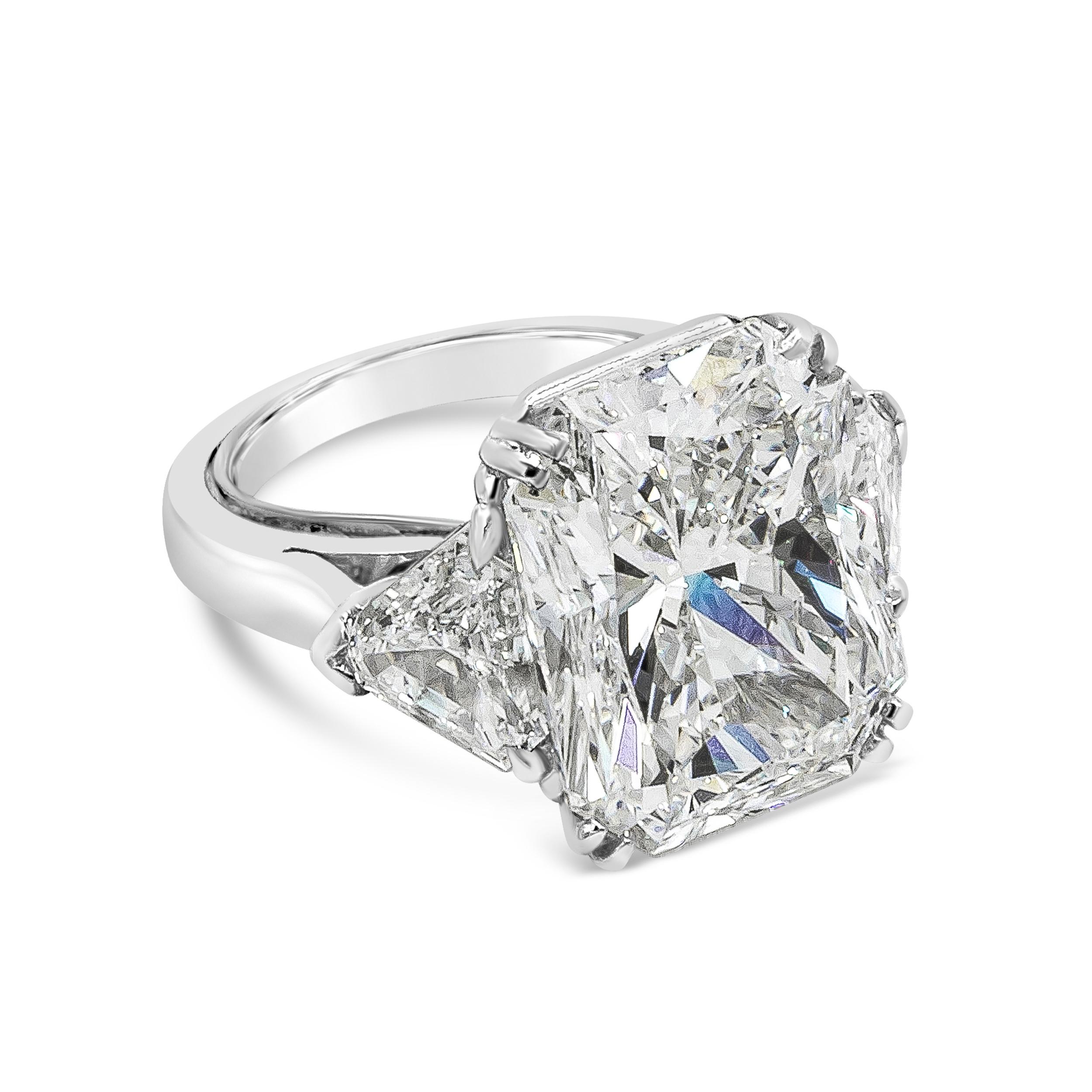 An exquisite and elegant three-stone engagement ring showcasing a GIA Certified 15.09 carat radiant cut diamond, H Color and VVS2 in Clarity. Flanked by two brilliant trillion diamonds weighing 1.95 carats total. Made with Platinum. Size 5.5