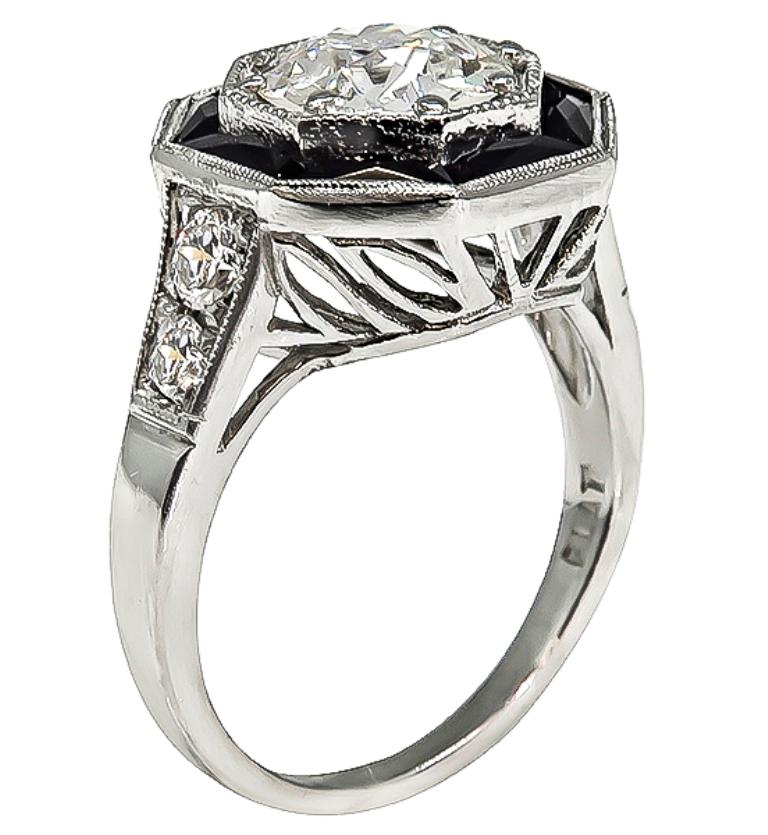 This stunning platinum engagement inspired from the Art Deco era, is centered with a sparkling GIA certified old European cut diamond that weighs 1.51ct. graded H color with SI1 clarity. The center diamond is accentuated by lovely faceted cut onyx