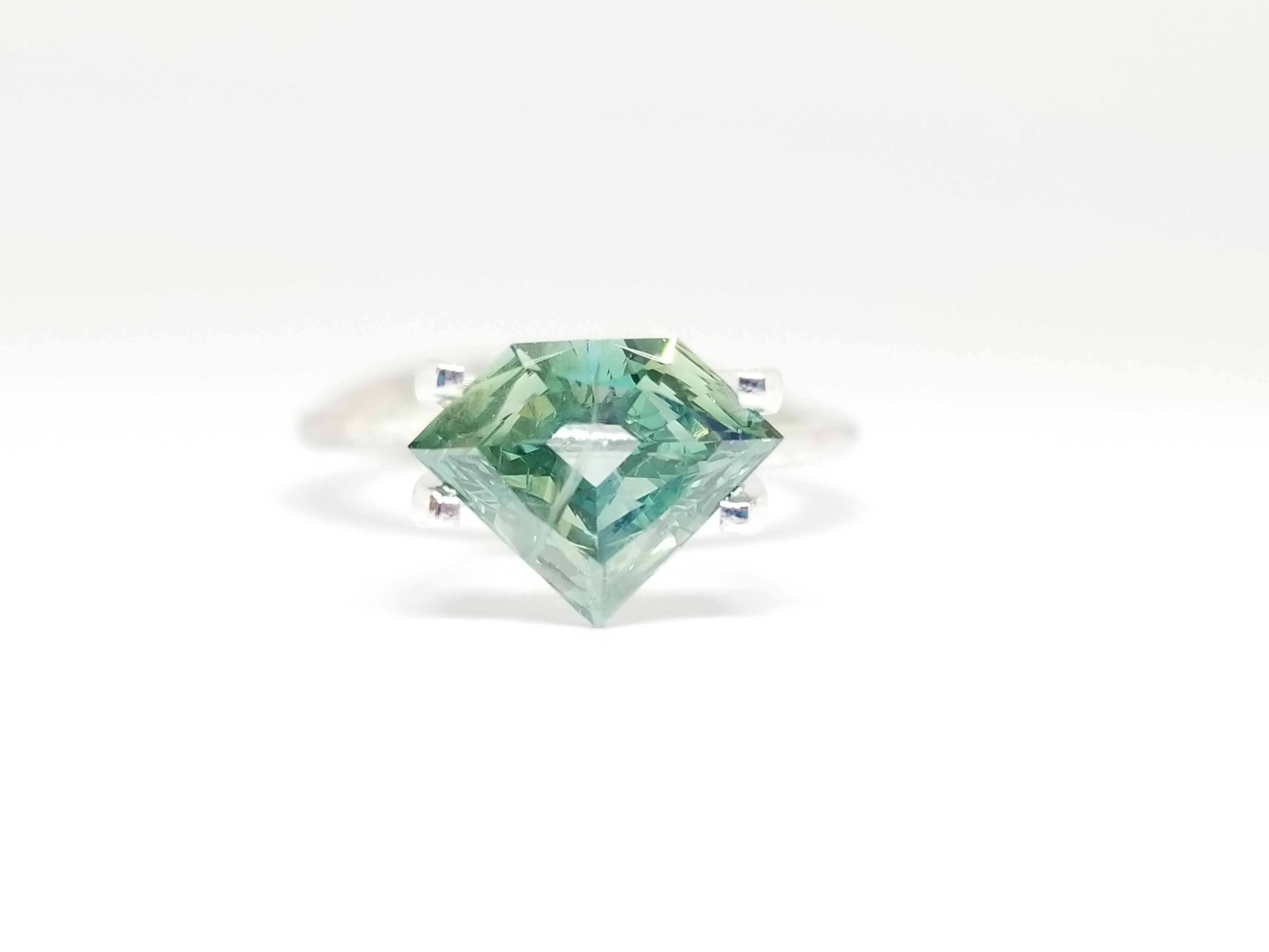 One very special piece shield shape diamond with transparent bluish green color weighing 1.51 carats by GIA. Treated clarity. Set on 4-prong 14K solitaire white gold. this ring is the ultimate gift for anniversaries, birthdays, and all