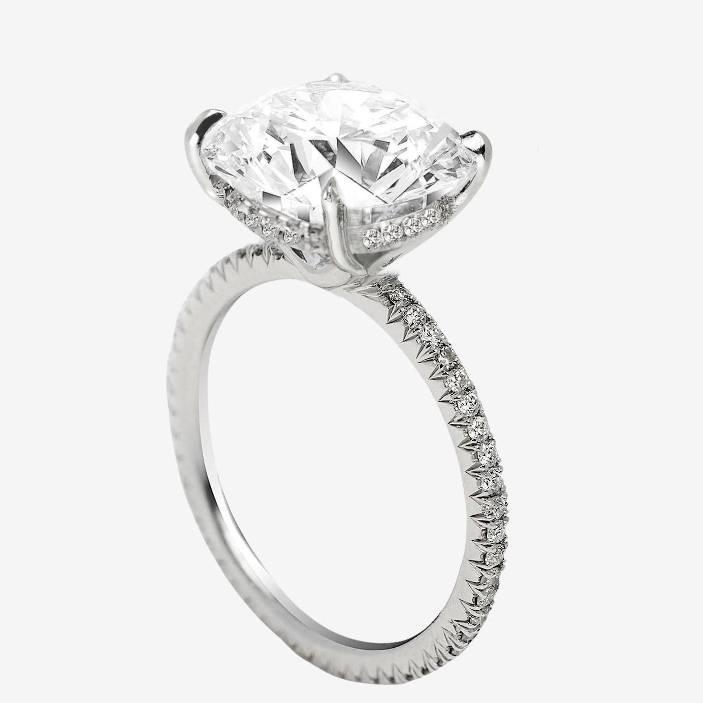 This graceful engagement ring features a 1.50-carat round cut diamond, GIA certified and celebrated for its timeless brilliance. The center stone is crafted with an excellent cut, allowing for exceptional light performance and a radiant sparkle.
