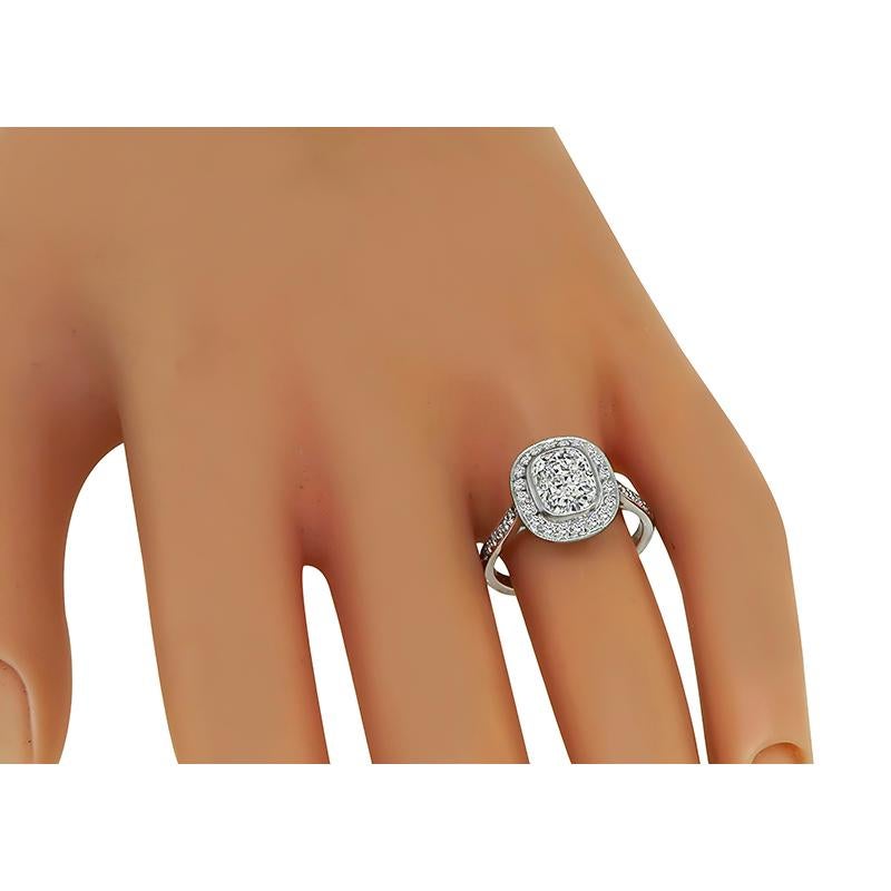 This is an elegant 18k white gold engagement ring. The ring is centered with a sparkling GIA certified cushion cut diamond that weighs 1.51ct. The color of the diamond is I with VS2 clarity. The center diamond is accentuated by dazzling round cut
