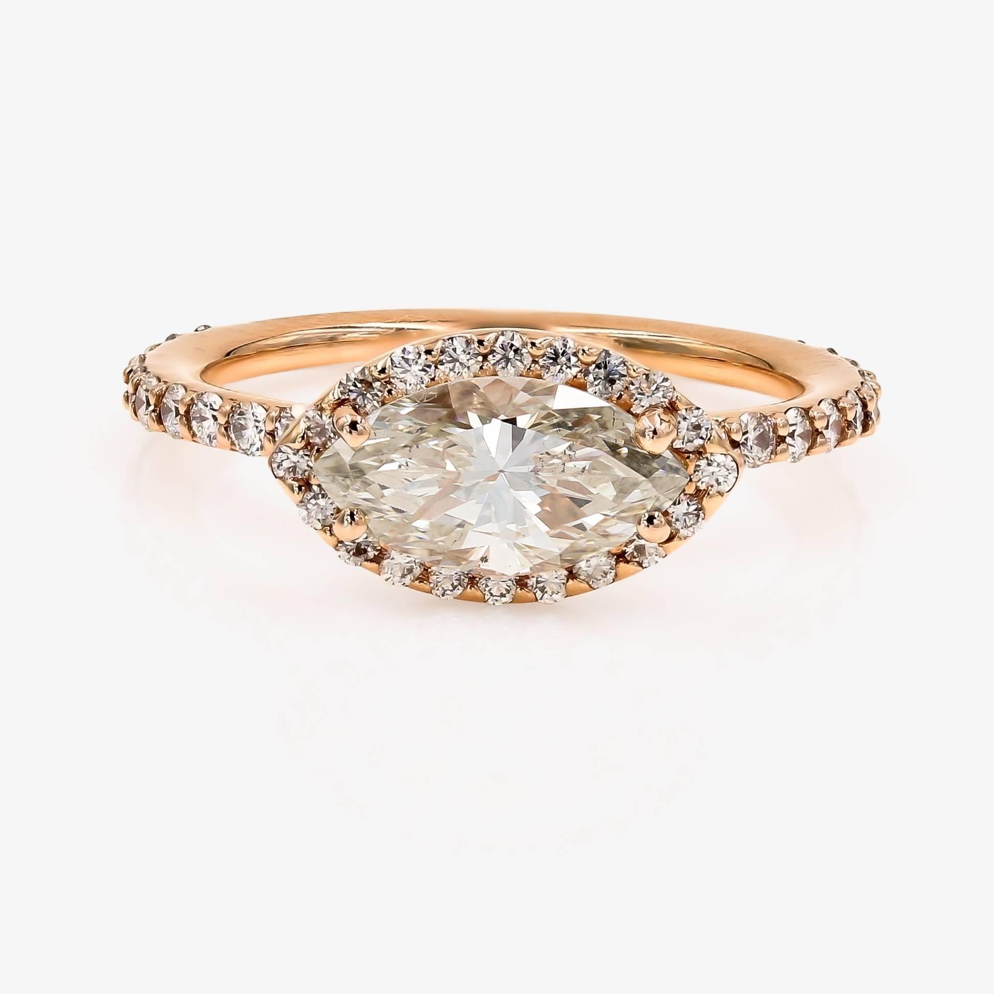This Lester Lampert D-Bead style setting in 18kt. rose gold, contains a 1.51cts. Marquise center that is K color and SI2 clarity. Surrounding the center and down the shank are 44 ideal cut round diamonds=.59ct. t.w.

This pieces comes with GIA