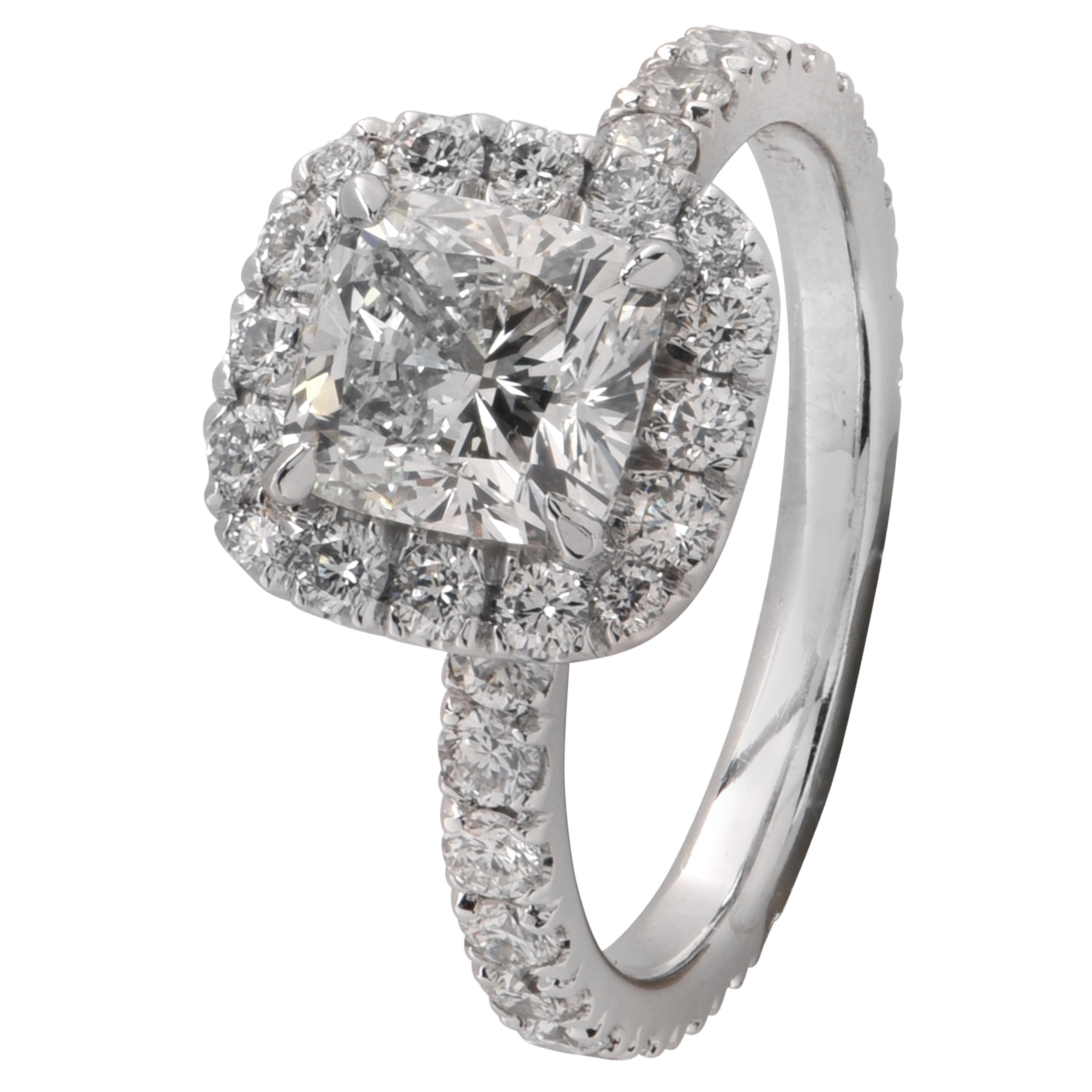 Spectacular engagement ring, custom made in platinum, showcasing a GIA certified cushion cut diamond weighing 1.52 carats, H color, VS1 clarity, halo set with 36 round brilliant cut diamonds weighing approximately .96 carats total, G color VS