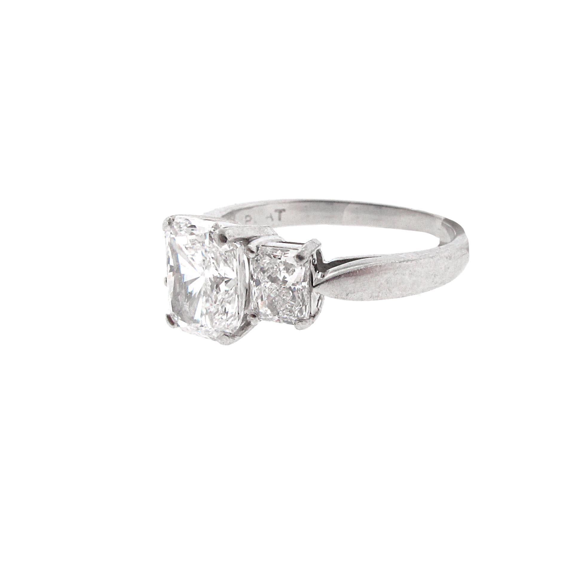 This is a GORGEOUS GIA Certified, 1.53 carat E-Si1 radiant diamond, three-stone engagement ring with side stones. This diamond is super white and of extremely high quality. This is the second whitest color diamond available. The stone is set between