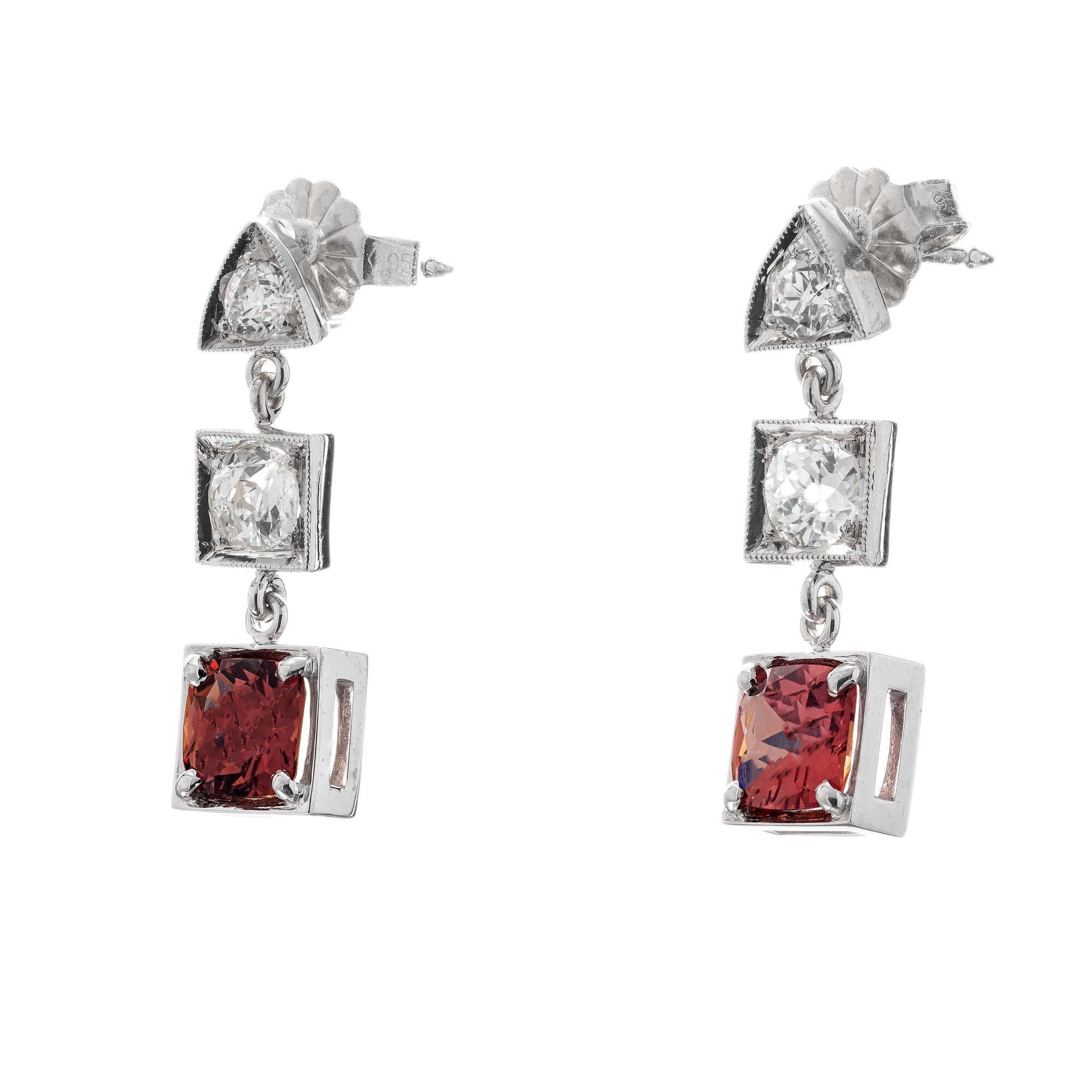 Art Deco Sapphire and diamond dangle earrings. GIA Certified natural no heat orange sapphire dangles with 4 old European accent diamonds in platinum square and triangle settings. Circa 1920's.

1 cushion brownish orange sapphire, VS SI approx.