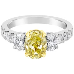 GIA Certified 1.53 Carats Oval Cut Yellow Diamond Three-Stone Engagement Ring