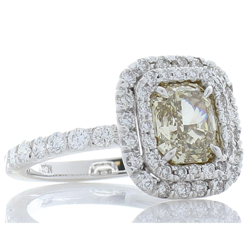 This ring features a GIA certified, 1.53 carat - 7.28 X 6.22 millimeter natural, fancy brownish yellow radiant-cut diamond. Its luster and transparency are excellent; its color is evenly distributed throughout the diamond. The warm, cinnamon-golden