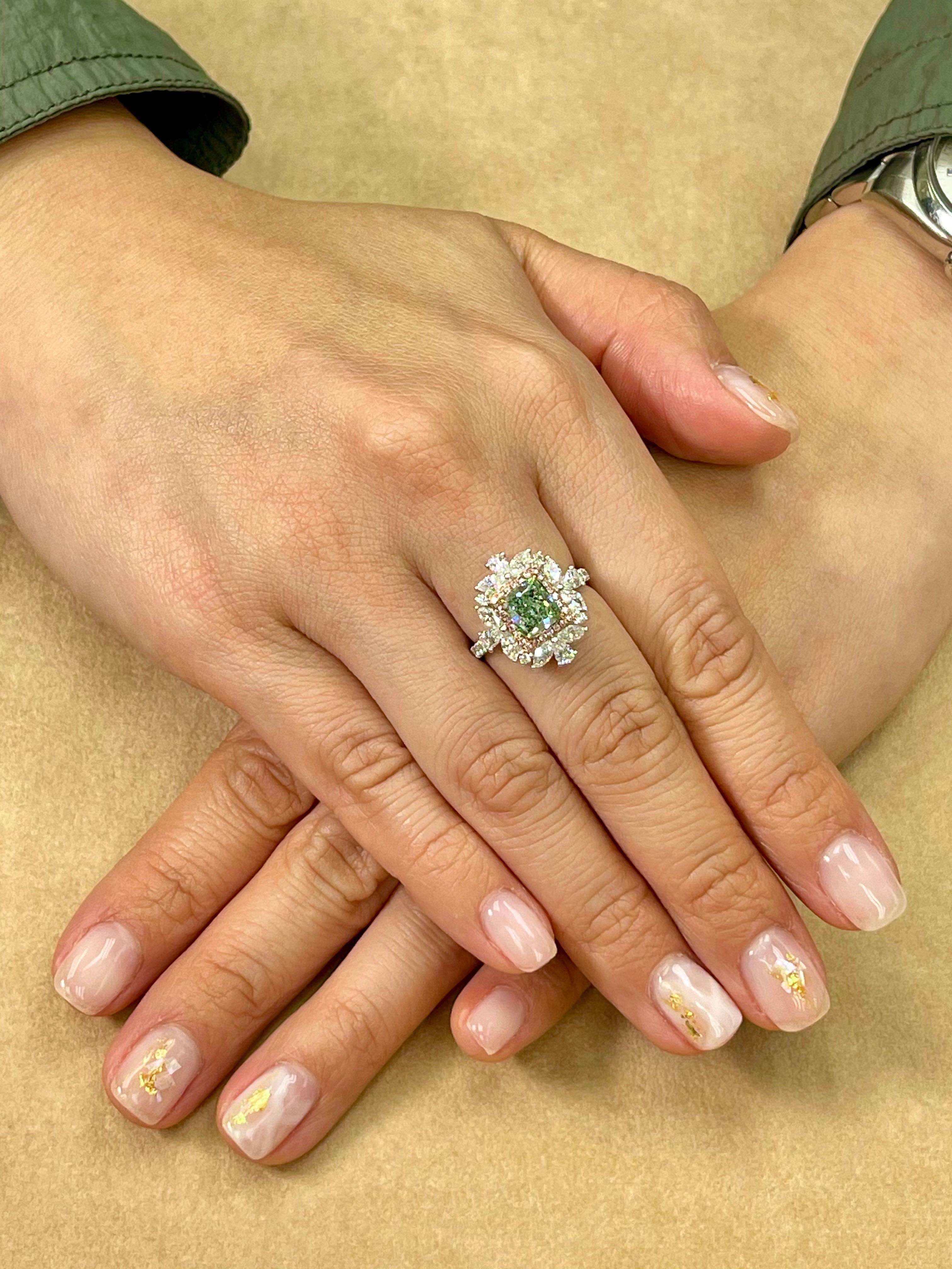 Please check out the HD video. Here is a super rare and unique fancy green diamond ring. This cocktail ring is set in 18k white gold. The center diamond is GIA certified 1.53 cts in weight and is rare to see. The natural diamond color is graded