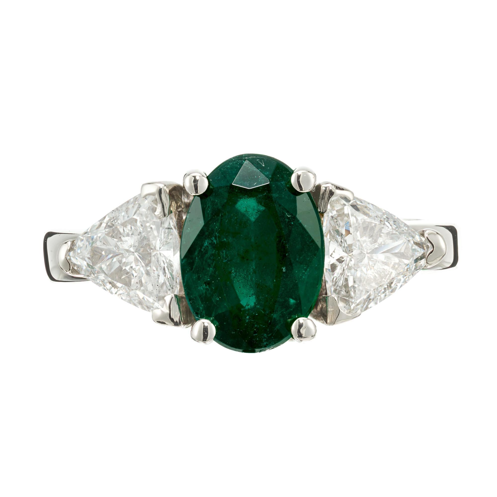Emerald and diamond engagement ring. GIA certified oval emerald center stone set in a 14k white gold three-stone setting with two well cut trilliant side diamonds. Certified low level F1 clarity enhancement only. 

1 oval gem green Emerald, approx.