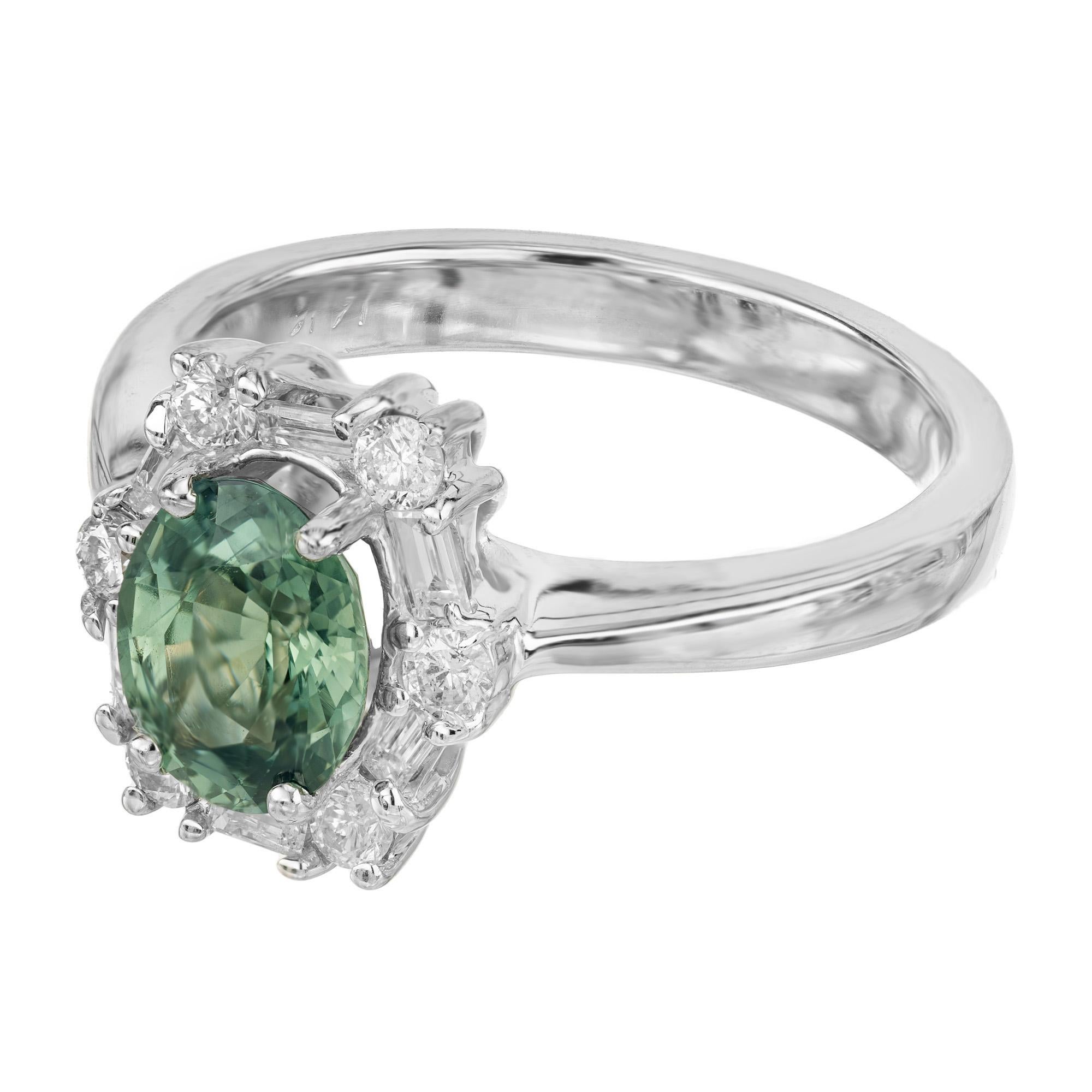 1960's GIA certified 1.54 carat oval natural blue green sapphire diamond engagement ring is a masterpiece of elegance and allure. The center stone is a beautiful green with a hue of blue that captivates with its extraordinary color and depth,