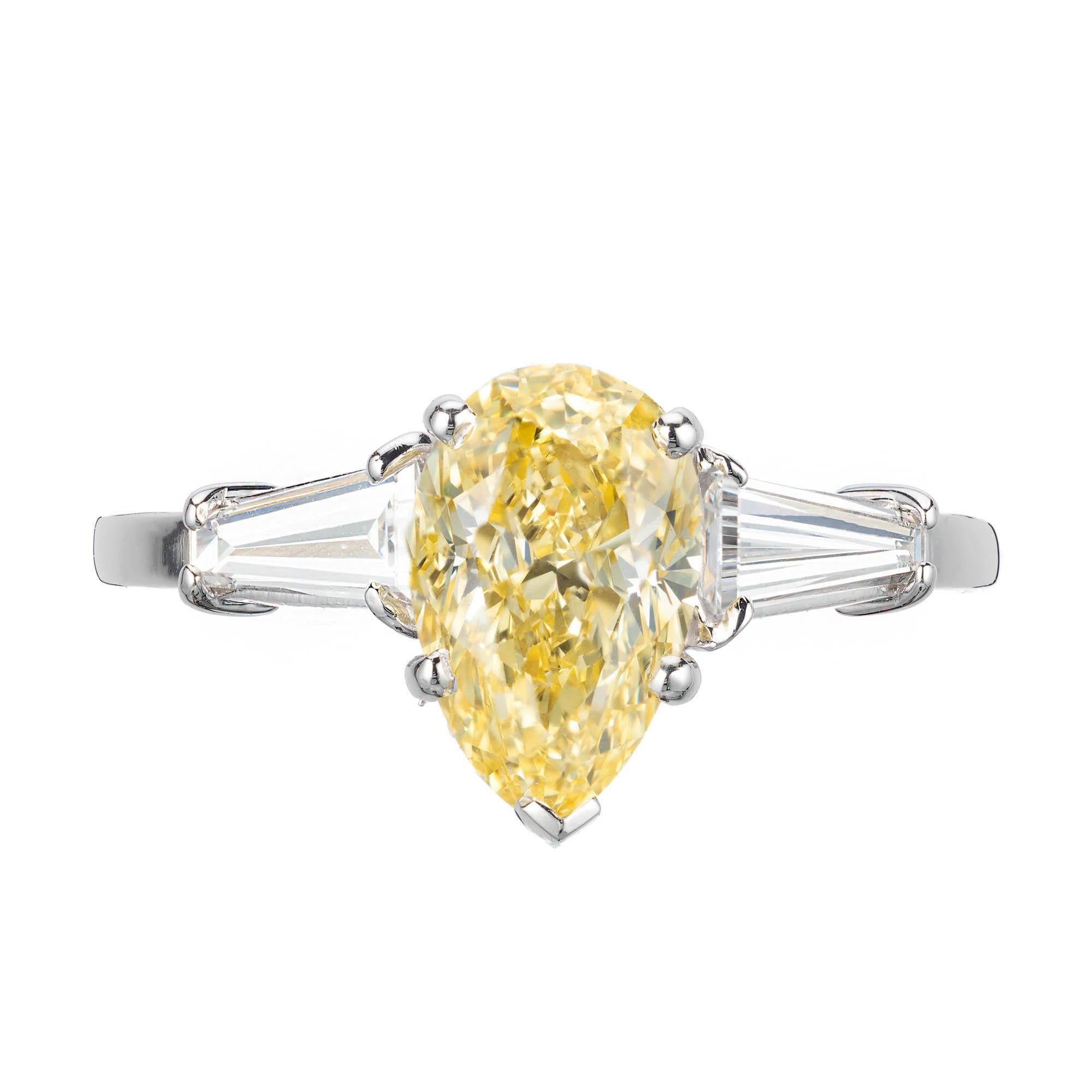 Vintage 1960s pear shape fancy intense yellow 1.54 carat diamond three-stone engagement ring. GIA certified center stone, very strong fancy intense color, accented with two baguette side diamonds in a platinum setting.

1 pear shape fancy intense