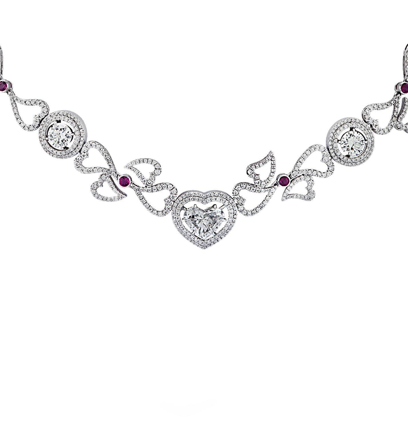 Sensational necklace crafted in 18 karat white gold showcasing a spectacular heart shape diamond weighing approximately 2.88 carats, G color, SI clarity, 3 GIA certified round brilliant cut diamonds weighing 2.44 carats total, H-I color, VS-SI
