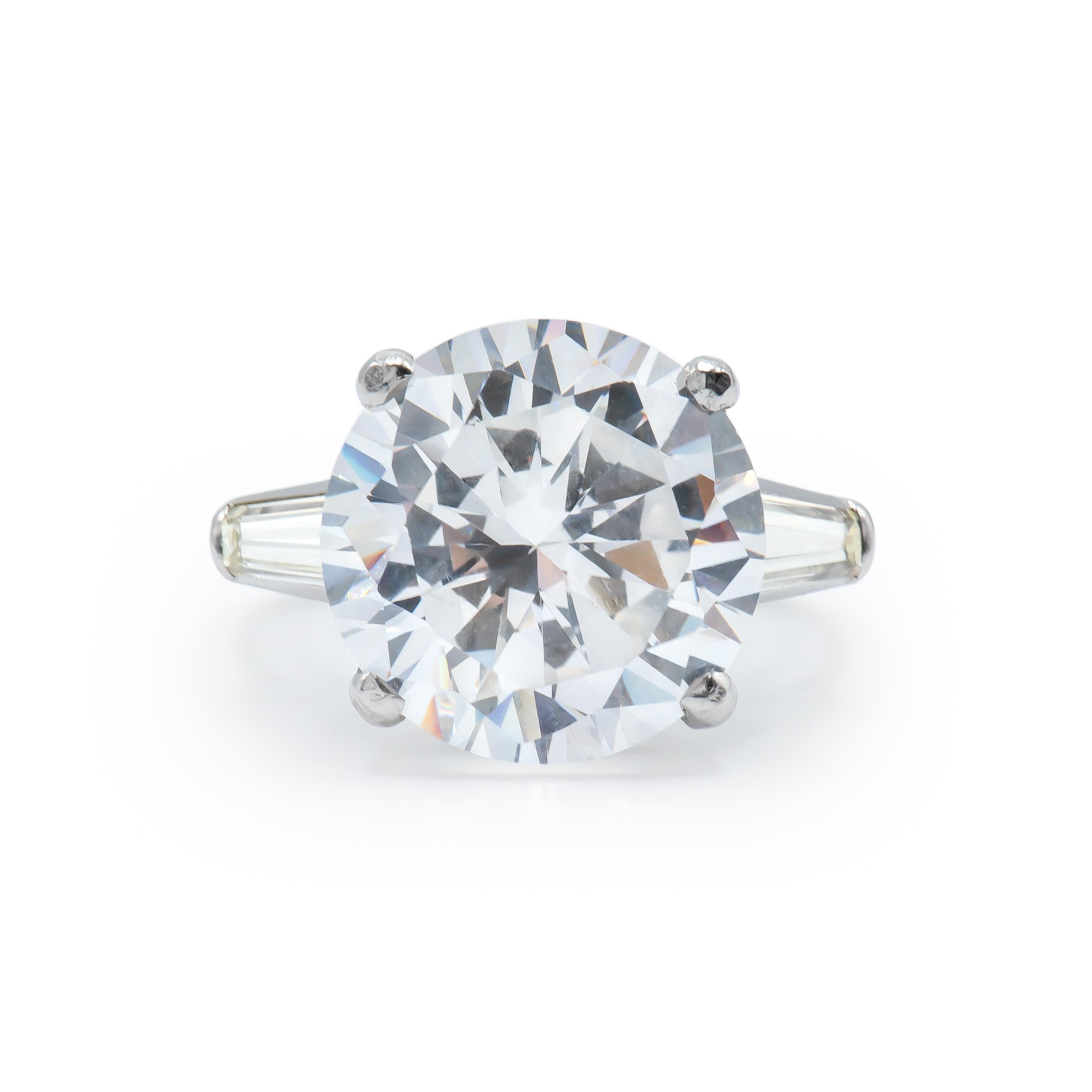 Round Diamond weighing 15.5 Carats, flanked by Tapered Baguette shaped Diamonds and set in Platinum.
Beautiful proportions and great life to this Diamond
Diamond is certified by GIA. K color. VS2 clarity
Set in Platinum.
Size 6.

Style available in