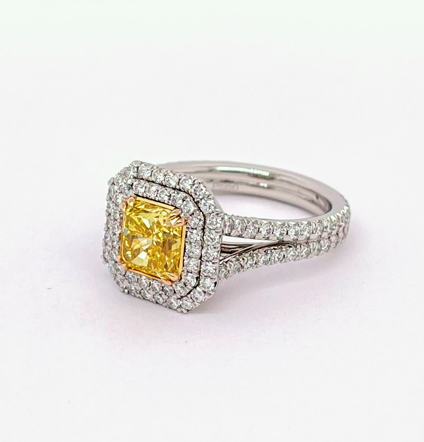 GIA Certified Round Shape Cut Diamond 1.55, Fancy Vivid Yellow Color VVS1 Clarity with 1.16 total carat weight of the double halo and shank which gorgeously makes the ring even special. Mounted a Platinum setting and  18K Yellow Gold basket and