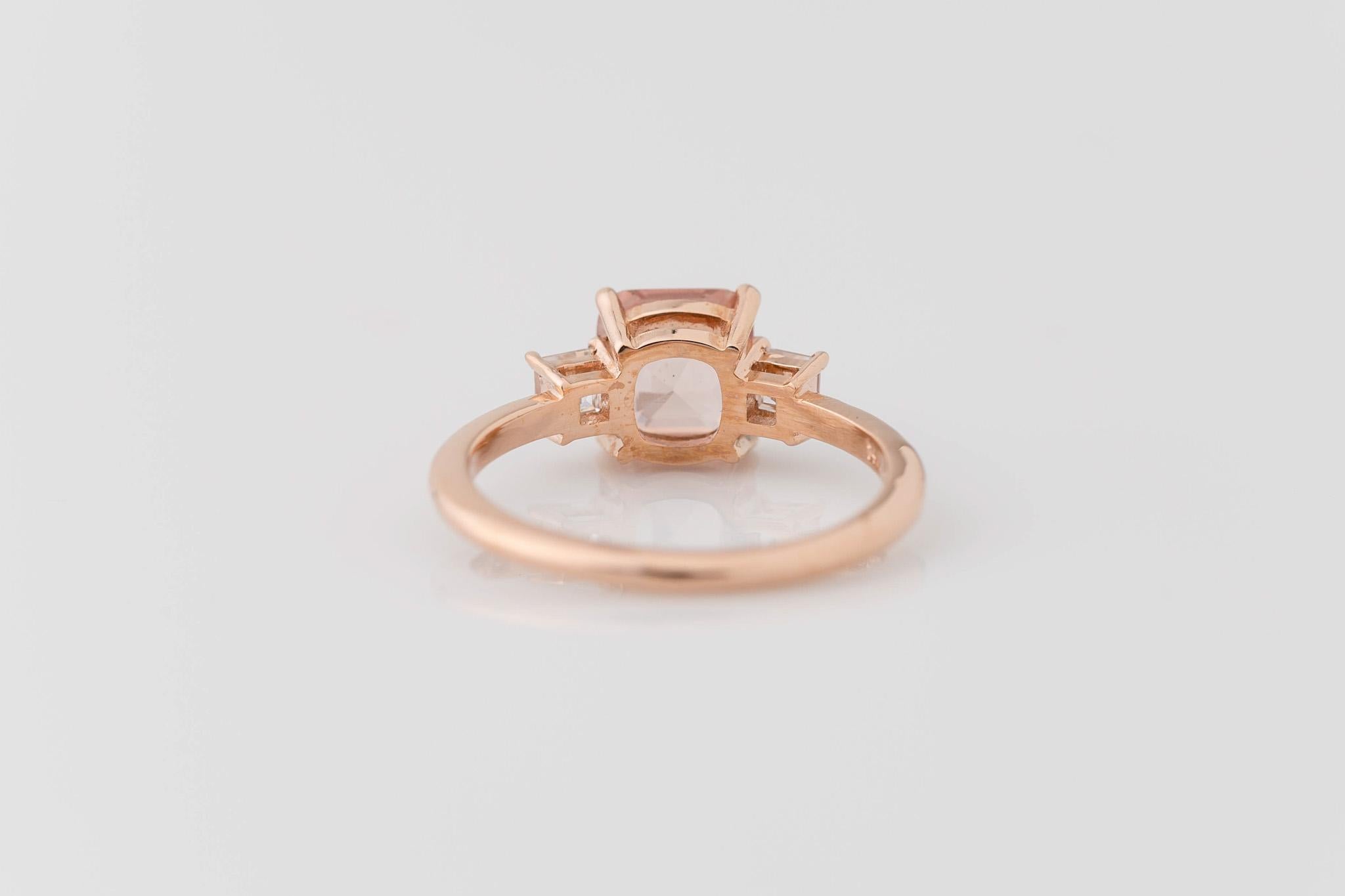 Dazzle with this elegantly understated GIA-certified 1.56-carat cushion-cut unheated Padparadscha sapphire diamond ring in 14k rose gold. The center stone boasts this rare sapphire's unmistakable captivating pinkish-orange hue reminiscent of a