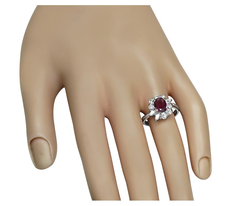 This is a gorgeous platinum engagement ring. The ring is centered with a lovely GIA certified oval cut no heat ruby that weighs 1.54ct. The center stone is accentuated by sparkling pear and round cut diamonds that weigh approximately 0.88ct. The