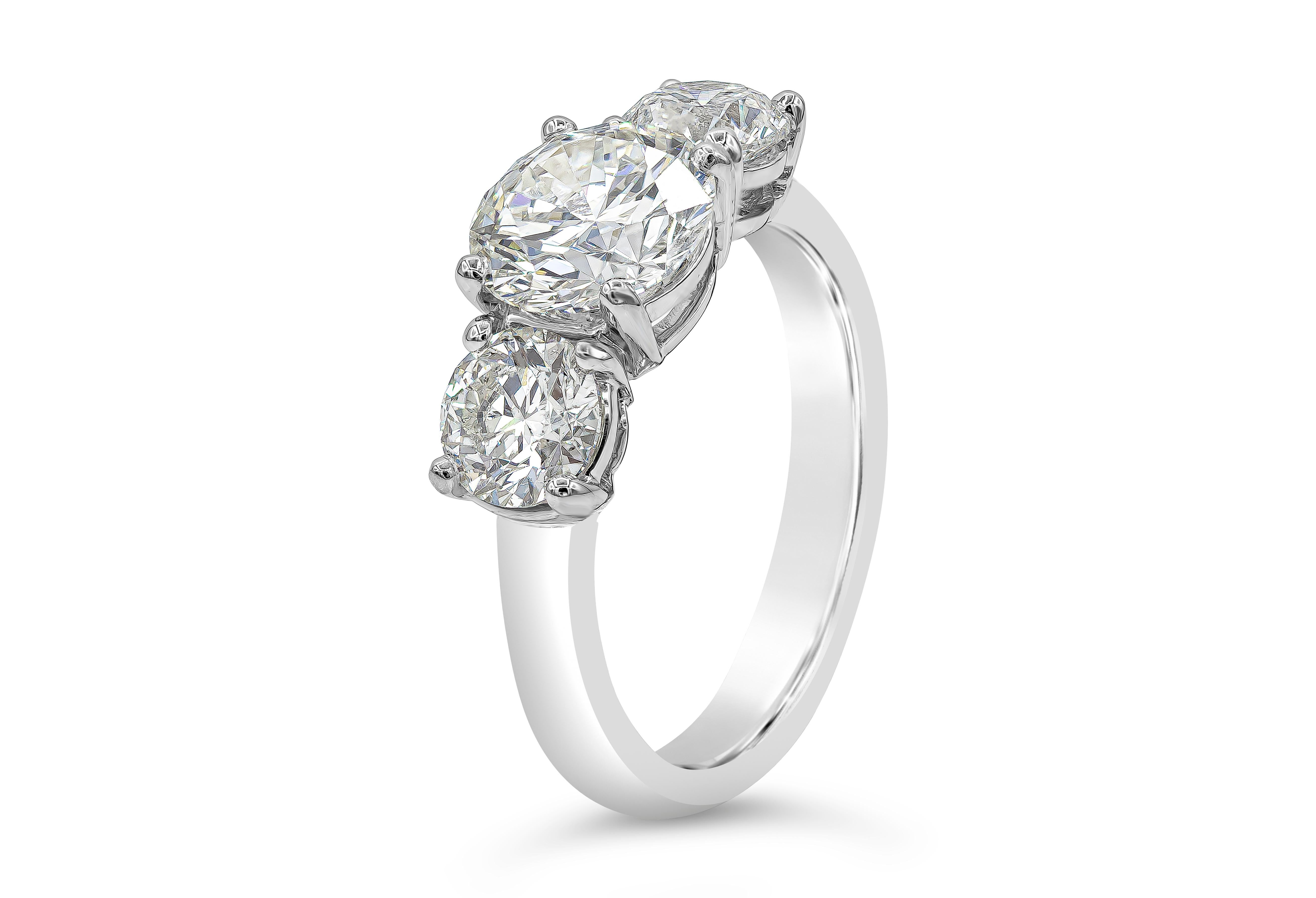 A brilliant engagement ring style showcasing a 1.58 carat round brilliant diamond certified by GIA as H color, I1 clarity. Flanking the center are two smaller round brilliant diamonds weighing 1.18 carats total. Set in an everlasting platinum
