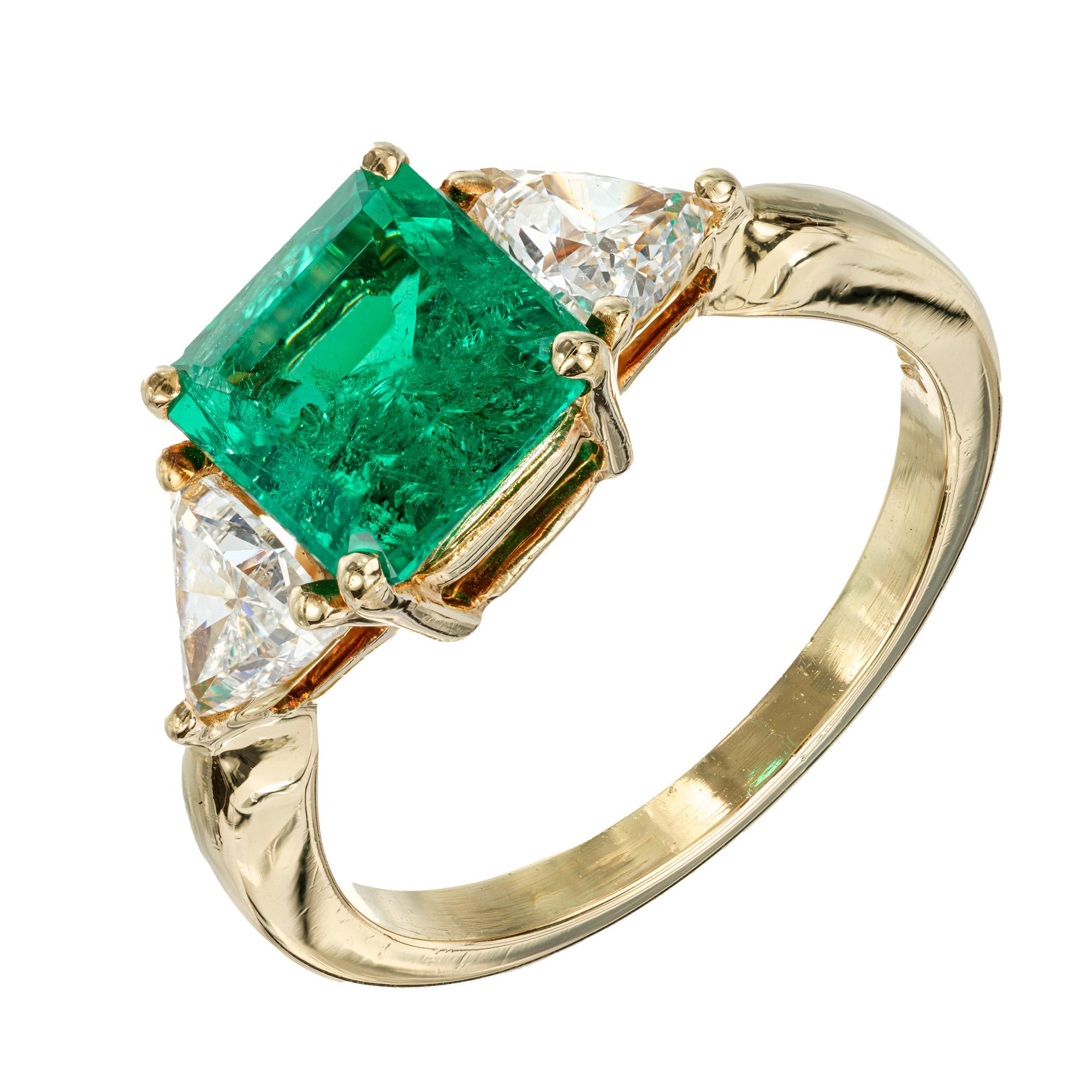 1960's Emerald step cut Emerald and trilliant cut diamond, engagement ring. GIA certified center Emerald set in a 18k yellow gold setting with 2 trilliant side diamonds. 

1 top gem Emerald cut Columbian green Emerald, approx. total weight 1.60cts,
