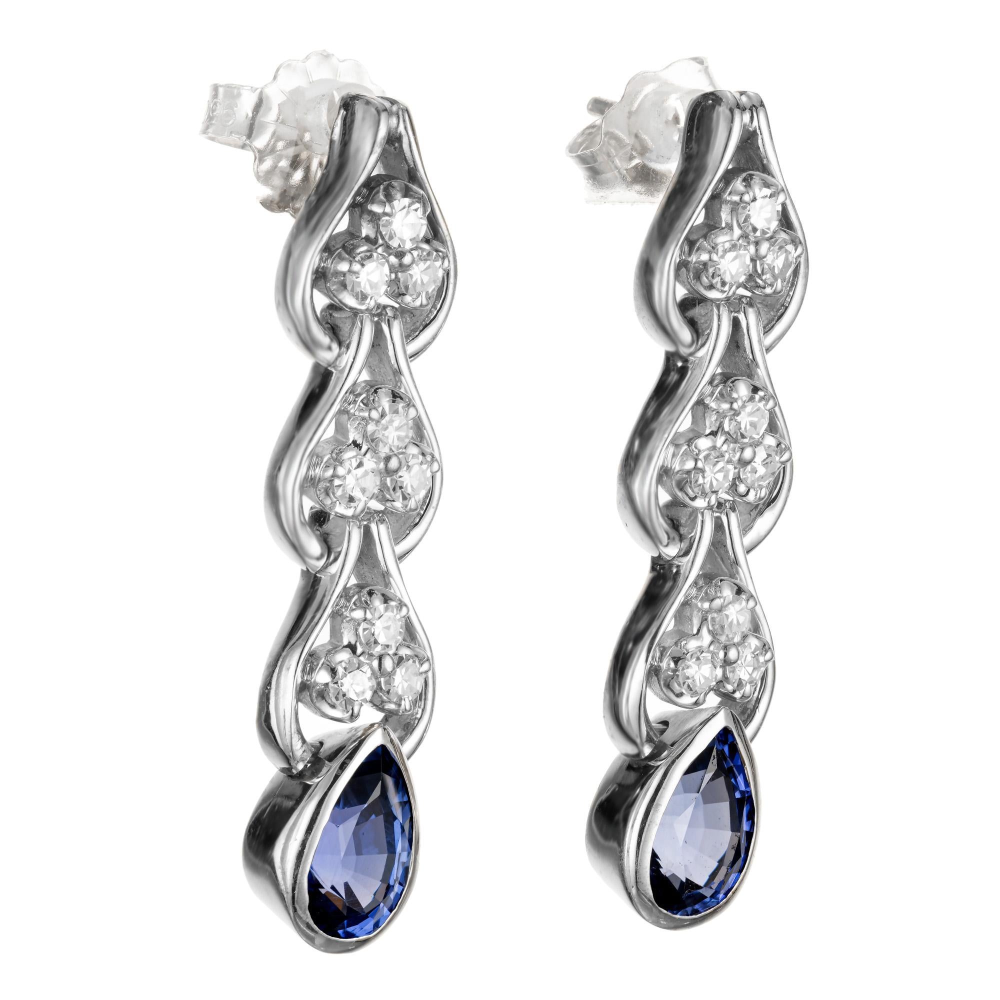 1960's Diamond and Sapphire dangle drop earrings. 9 round cut diamonds with a pear shaped bezel set sapphire at the bottom of each earring.  GIA certified. 

2 natural no heat pear shaped blue Sapphires, .77ct and .83ct. GIA certificate numbers: