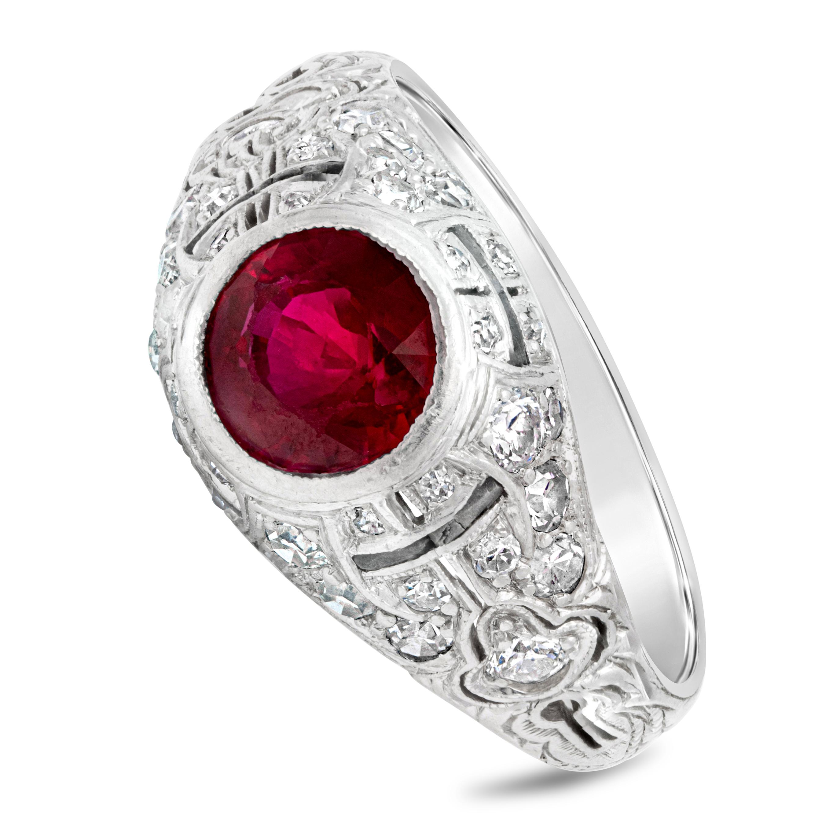 An antique piece of jewelry showcasing a GIA certified color-rich round ruby center stone weighing 1.60 carats, set in a bezel. Flanked on each side by a round diamonds weighing 1.00 carats total. Made with platinum. Size 8 US and resizable upon