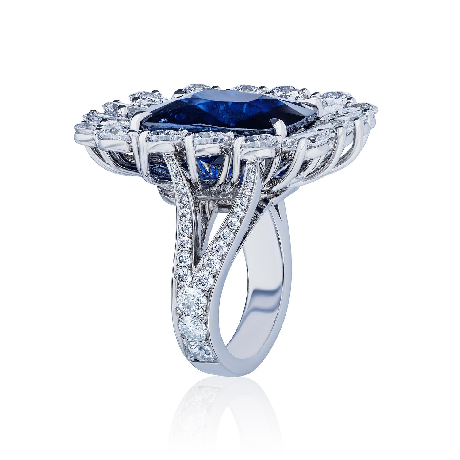 Centered upon a 16.07 Carat Cushion Cut Sapphire surrounded by Pear shaped Diamonds of D-E Color and SI Clarity. Diamonds set on a split shank.

Set in Platinum.