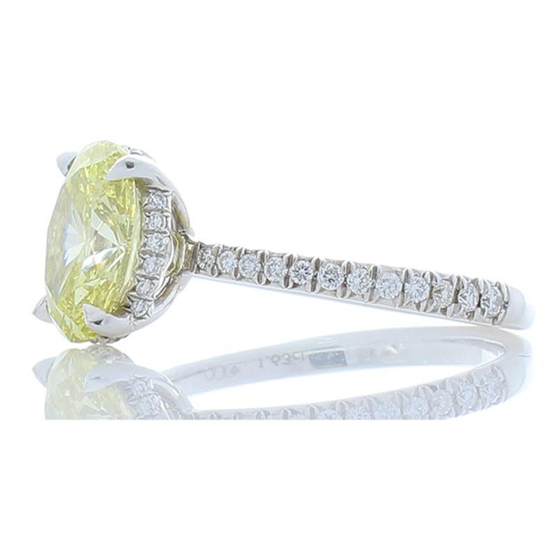 This stunning ring will delight her for a lifetime! The eye fixates first, on the exceptionally striking lemon fancy yellow that is GIA certified weighing 1.63 Carat- 8.89 X 6.80 millimeter oval diamond. Then, your eye is drawn to the 0.25 carat