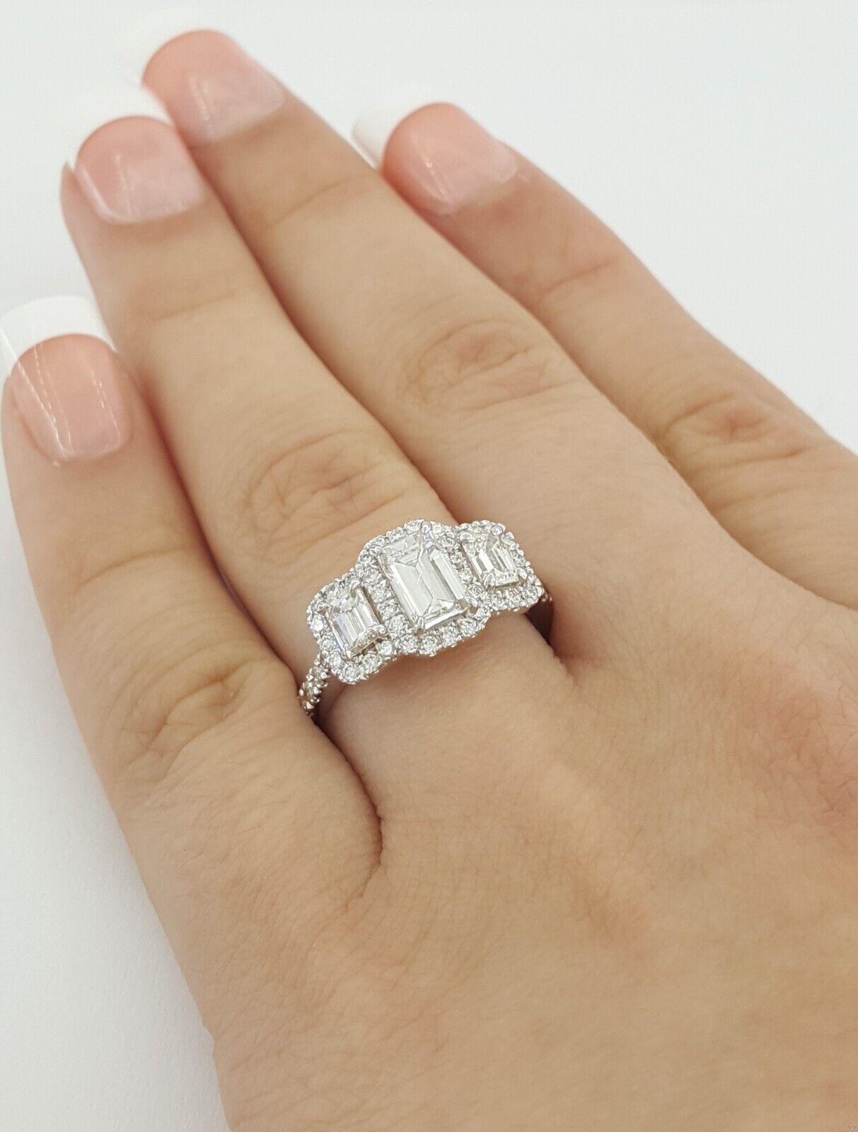GIA Certified 1.63 Carat Total Weight Three-Stone Emerald Cut Diamond Halo Ring in 14K White Gold

This beautifully crafted engagement ring features a GIA-certified emerald cut center diamond, weighing 0.71 carats, graded F color, SI1 clarity, with