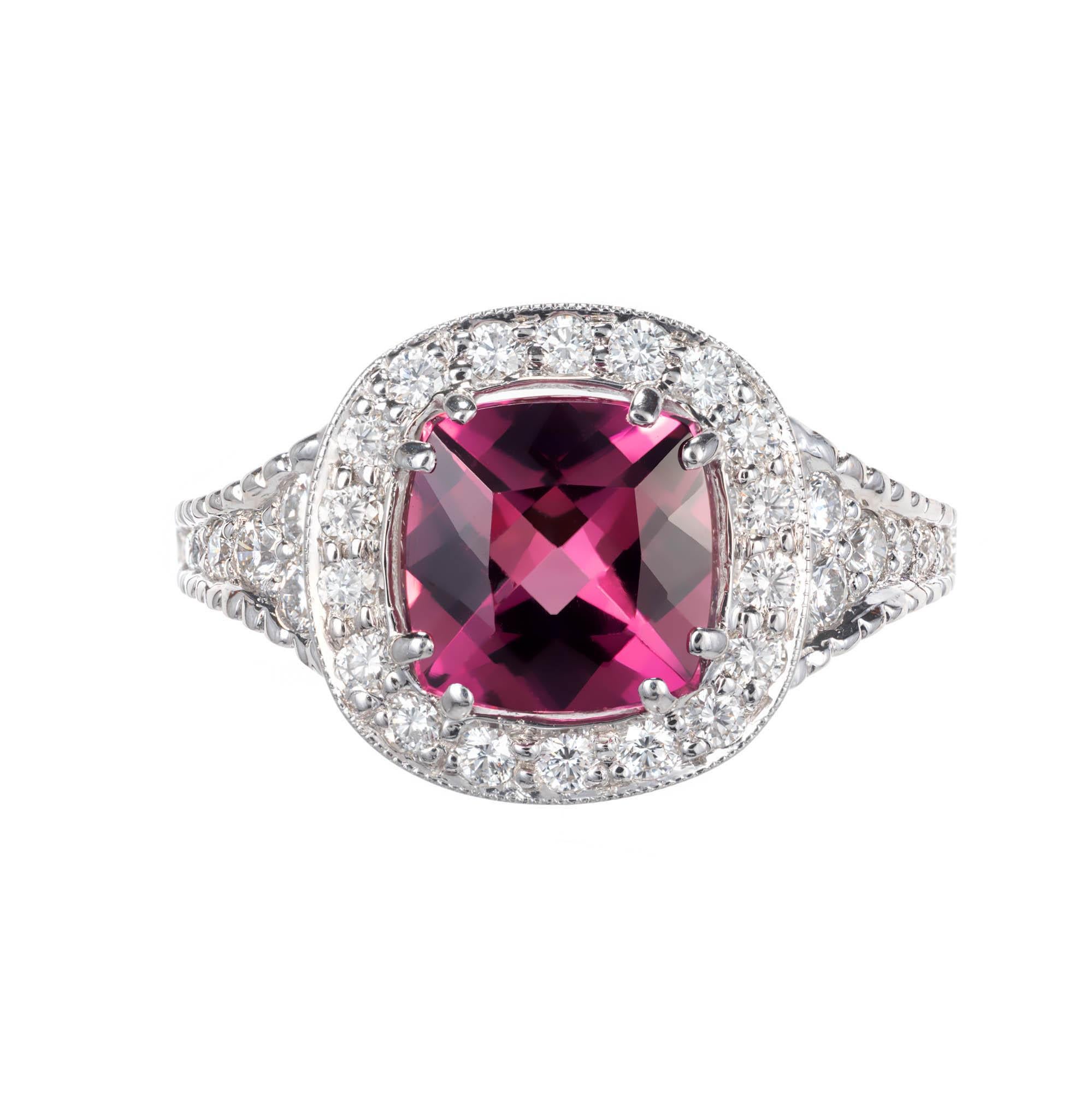 18k white gold Tourmaline & Diamond  engagement ring. Cushion shaped pink Tourmaline surrounded by a cushion shaped halo of round brilliant cut Diamonds accented with graduating sides of round brilliant cut Diamonds in the band. Filigree under