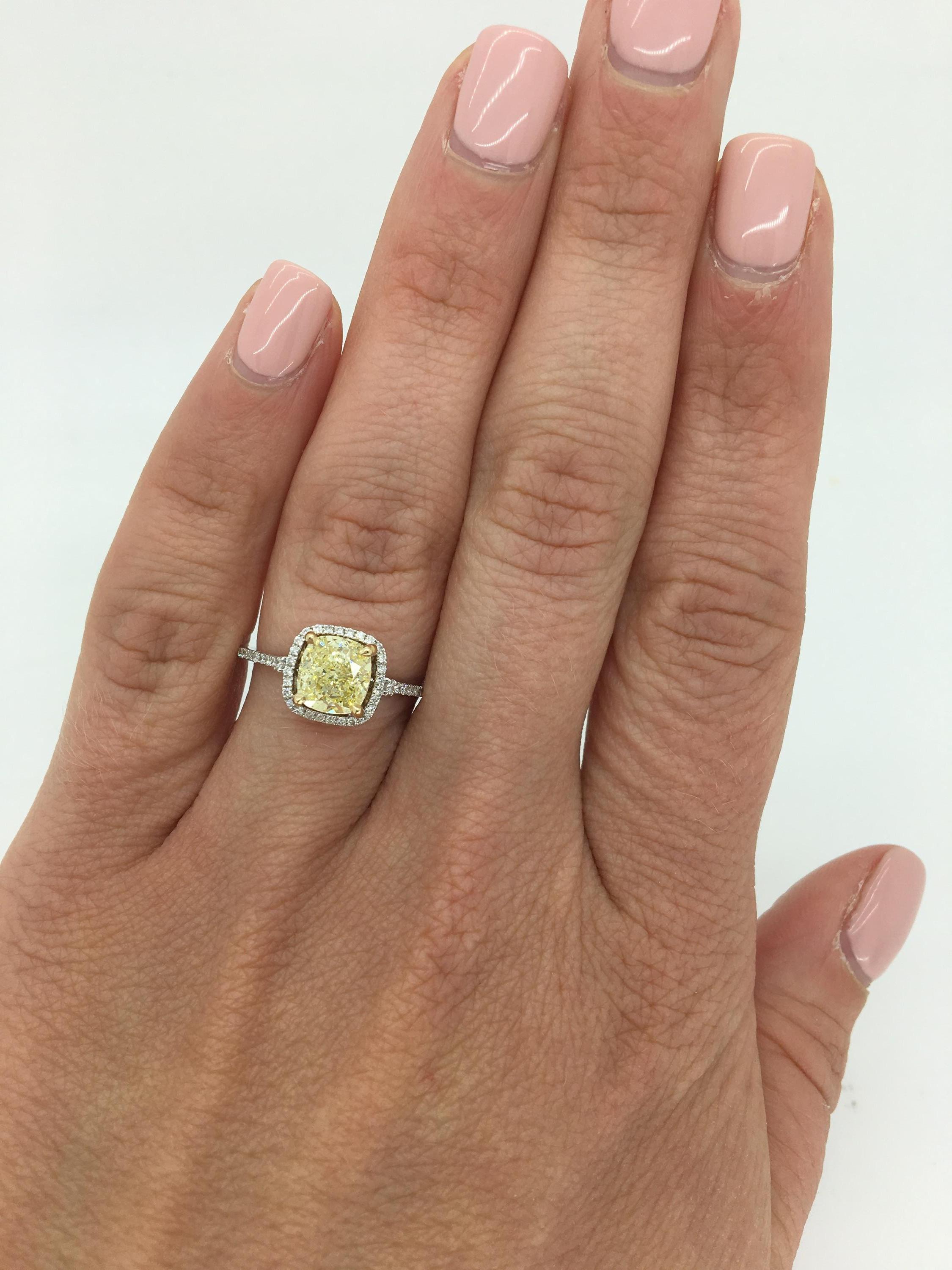 This beautiful ring features a GIA Certified 1.42CT Fancy Light Yellow Diamond with an elegant halo of white round brilliant cut diamonds surrounding it.

 
GIA #2181144601
Center Diamond Carat Weight: 1.42CT
Center Diamond Cut: Cushion Modified